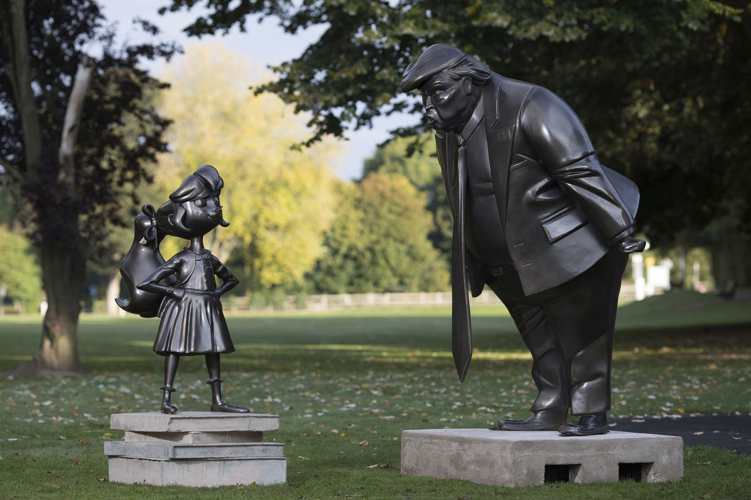 A statue of Roald Dahl's Matilda is unveiled in Great Missenden in Buckinghamshire, alongside one of President Donald Trump, to celebrate the 30th Anniversary of Matilda the novel. (David Parry—PA Wire/AP)