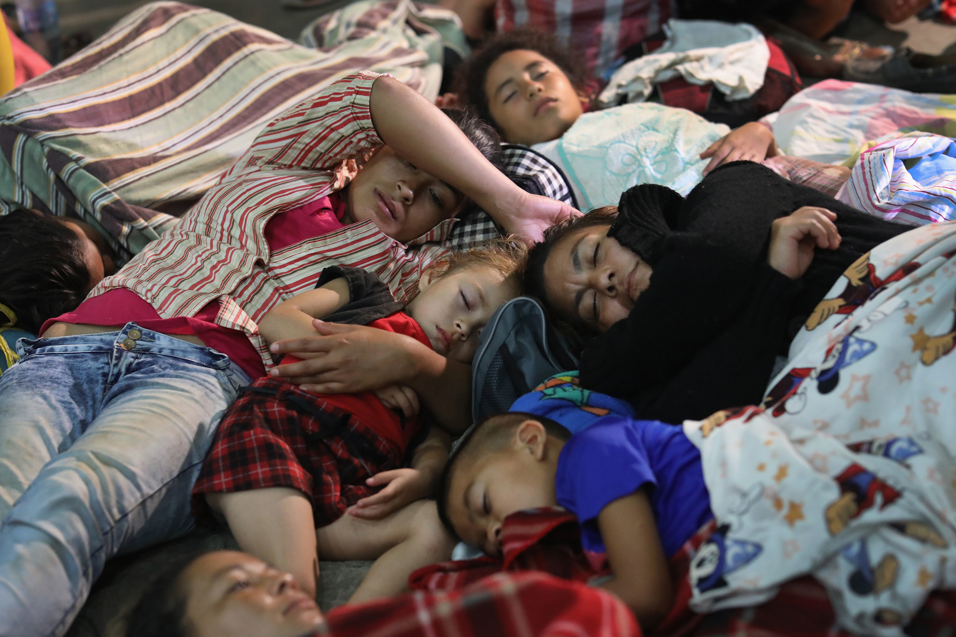 Families of immigrants rest for the night in a community gym in Chiquimula, Guatemala, on Oct. 16. (John Moore—Getty Images)