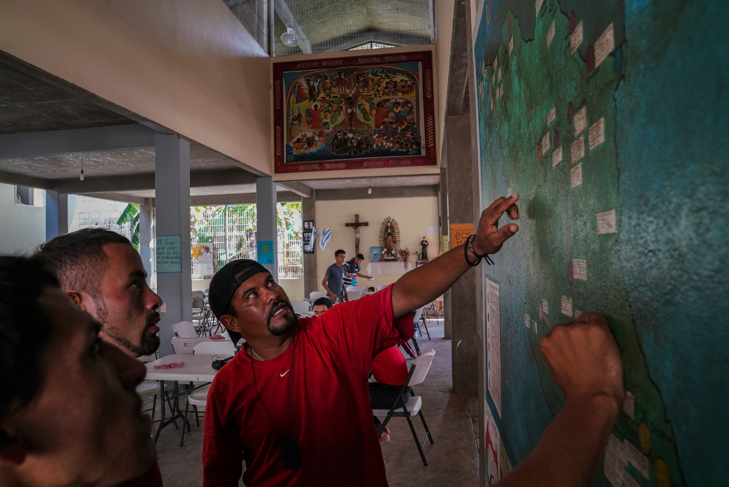 Miguel Alvarado, 36, explains the different routes that migrants can take at a shelter near Palenque, Chiapas, on Oct. 20. Miguel plans to work in the U.S. to be able to support his three kids who he left behind. He had heard about the caravan that is currently traveling through Mexico, but he decided not to join it because he is afraid they will soon be stopped. (Veronica G. Cardenas for TIME)