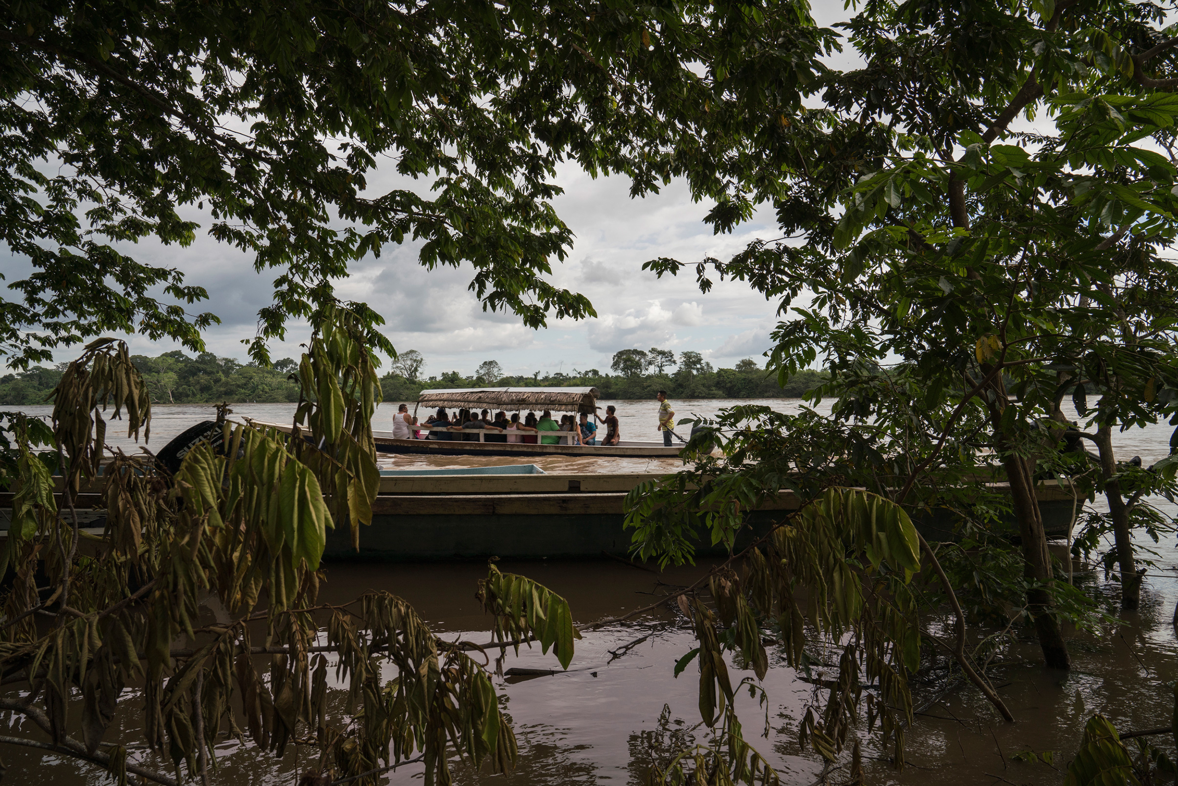 Migrants cross the Usumacinta River between La Técnica, Guatemala and Frontera Corozal, Mexico, on Oct. 21. The Usumacinta River acts as a border between the two countries. There is no immigration inspection in either of the two borders in the area. (Veronica G. Cardenas for TIME)
