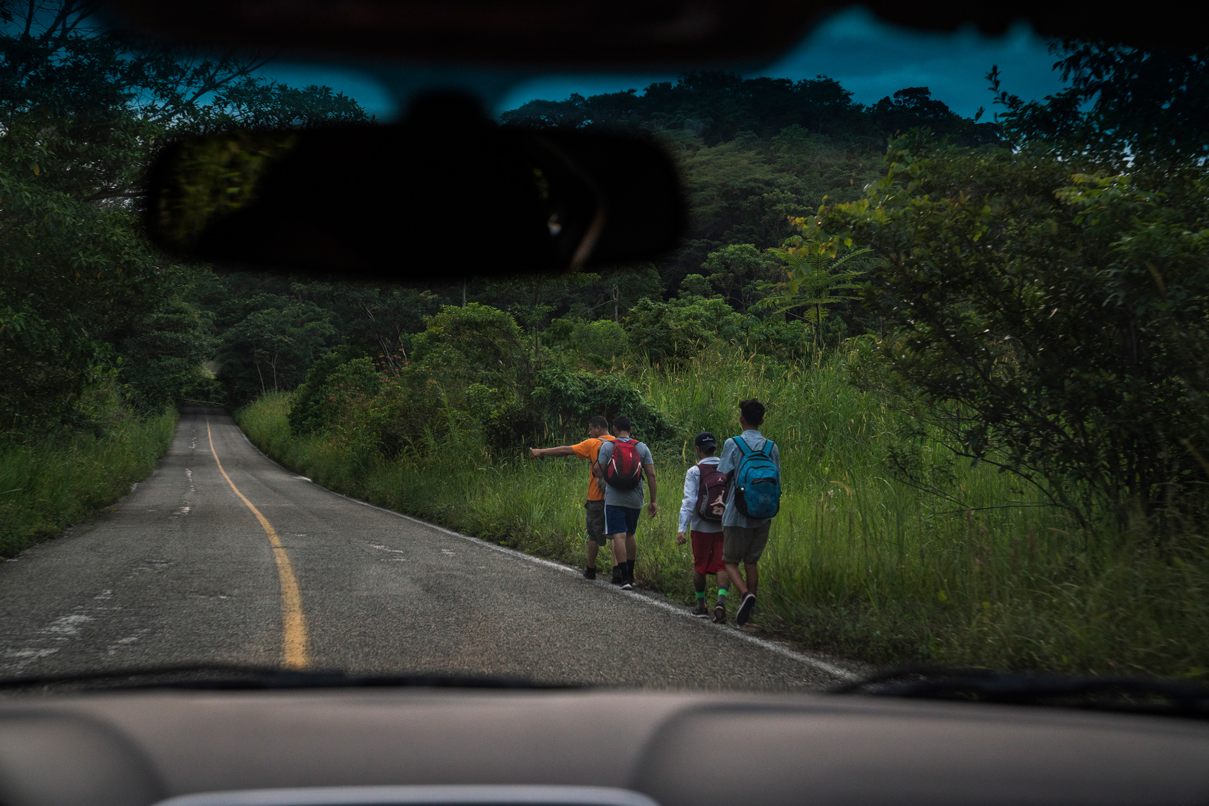 Migrants walk along a highway near Palenque, Chiapas, on Oct. 21. The highway is known by locals as “El Gran Corredor del Pacífico del Migrante,” or “The Great Pacific Corridor of the Migrant." This is a common route for Honduran migrants. (Veronica G. Cardenas)