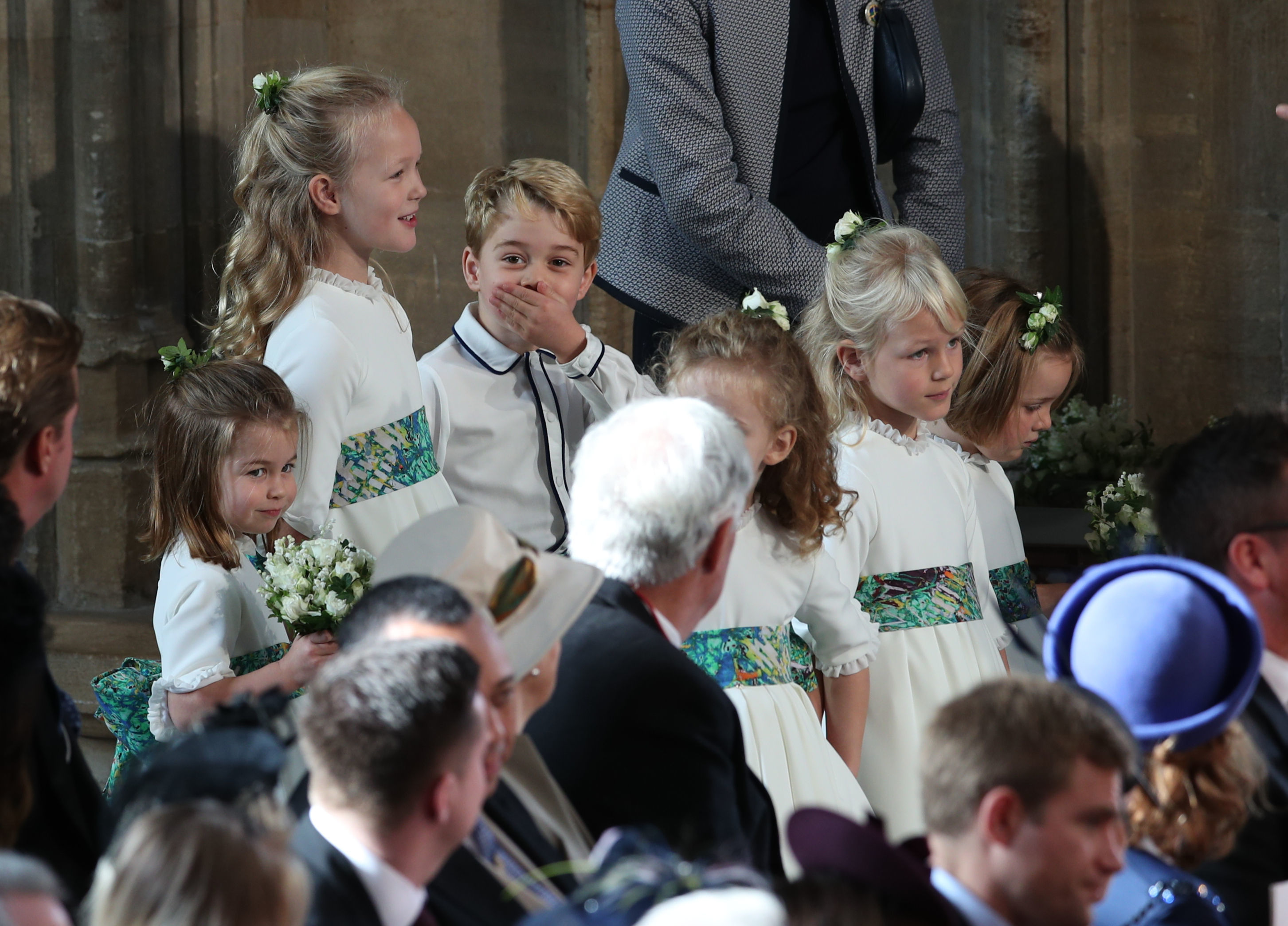 The bridesmaids and page boys, including Princess Charlotte of Cambridge (L), Savannah Phillips (2L) and Prince George of Cambridge (3L) wait to take part in the wedding of Britain's Princess Eugenie of York to Jack Brooksbank at St George's Chapel, Windsor Castle, in Windsor, on October 12, 2018. (Photo by Yui Mok / POOL / AFP) (Photo credit should read YUI MOK/AFP/Getty Images) (YUI MOK—AFP/Getty Images)