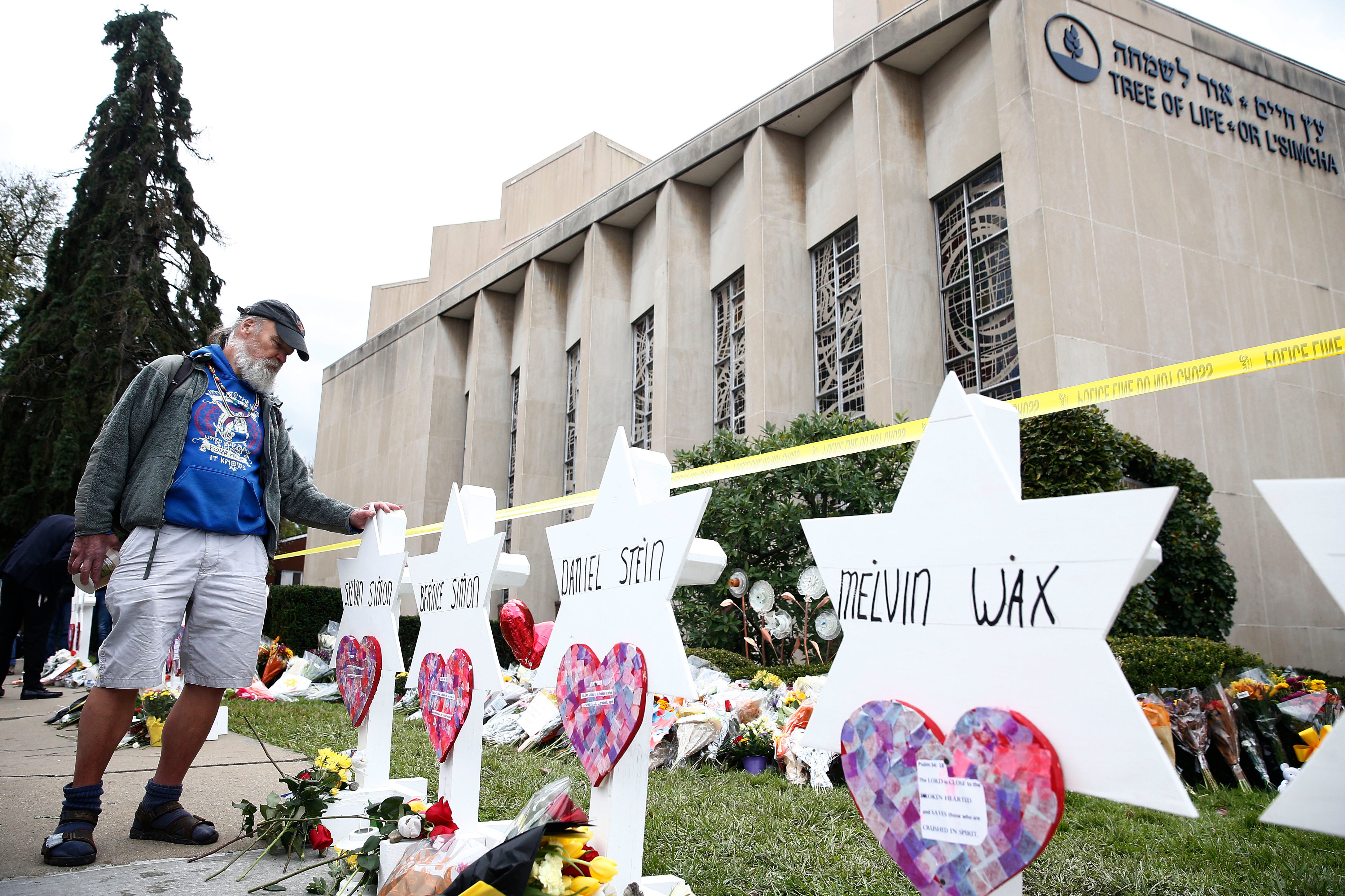 A man takes a moment at each of the Star of David memorials with the names of the 11 people who were killed at the Tree of Life synagogue two days after a mass shooting in Pittsburgh, Pennsylvania, on Oct. 29, 2018. (JARED WICKERHAM—EPA-EFE/REX/Shutterstock)