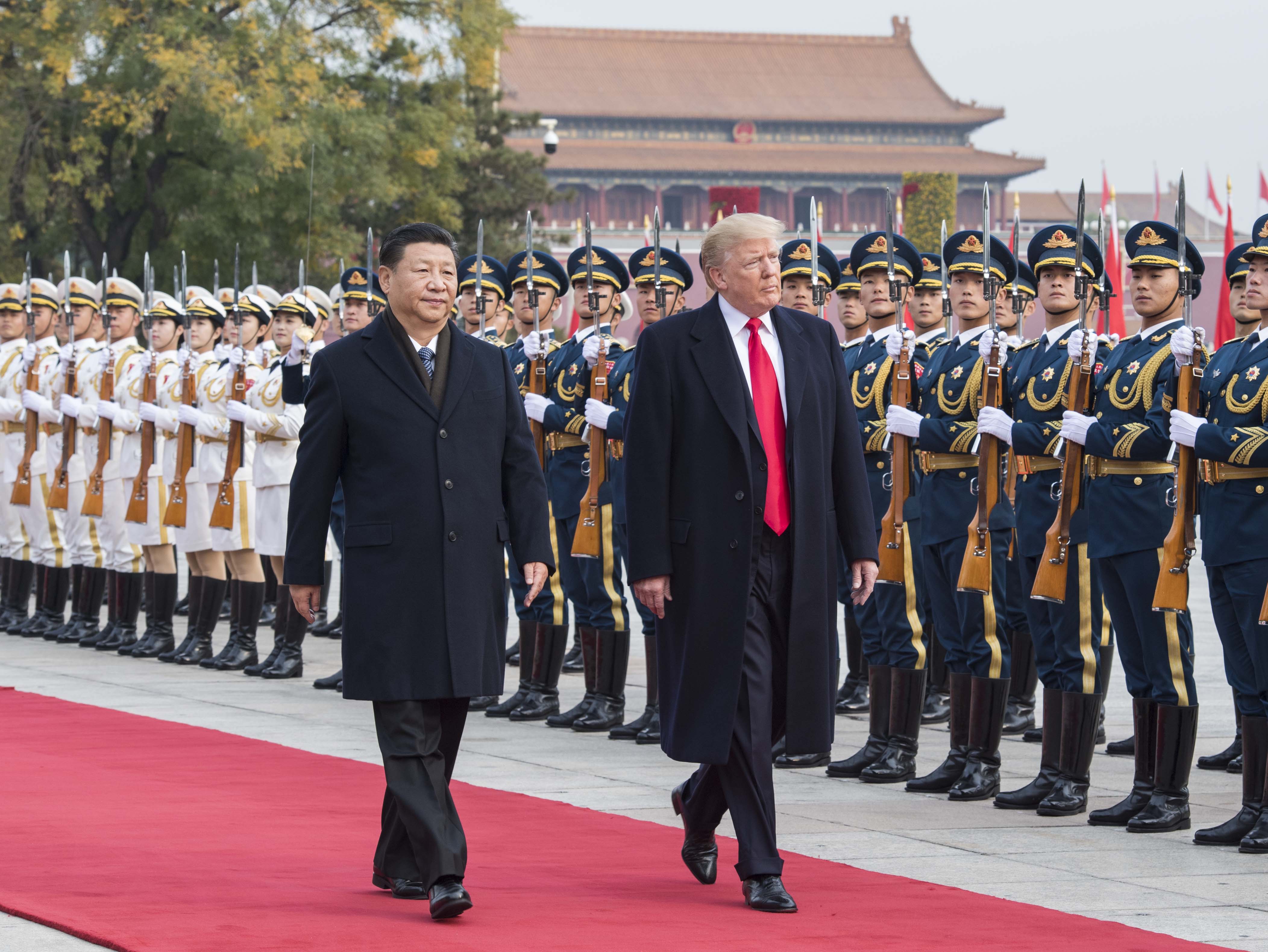Chinese President Xi Jinping (L) holds a grand ceremony to welcome U.S. President Donald Trump at the square outside the east gate of the Great Hall of the People in Beijing, China, on Nov. 9, 2017. (Xinhua News Agency/Getty Images)