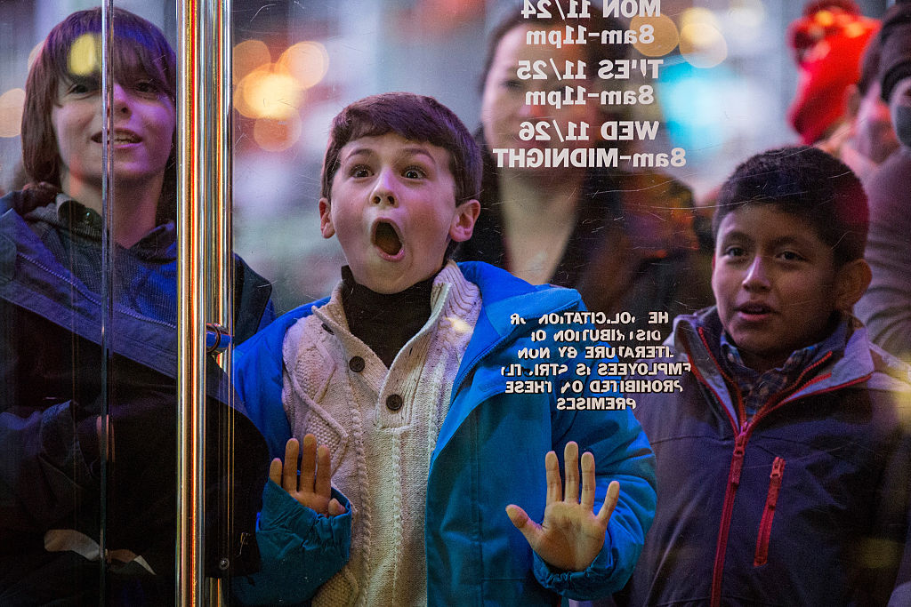 A boy waits to enter the Toys R Us in Times Square on November 27, 2014 in New York, United States. (Andrew Burton—Getty Images)