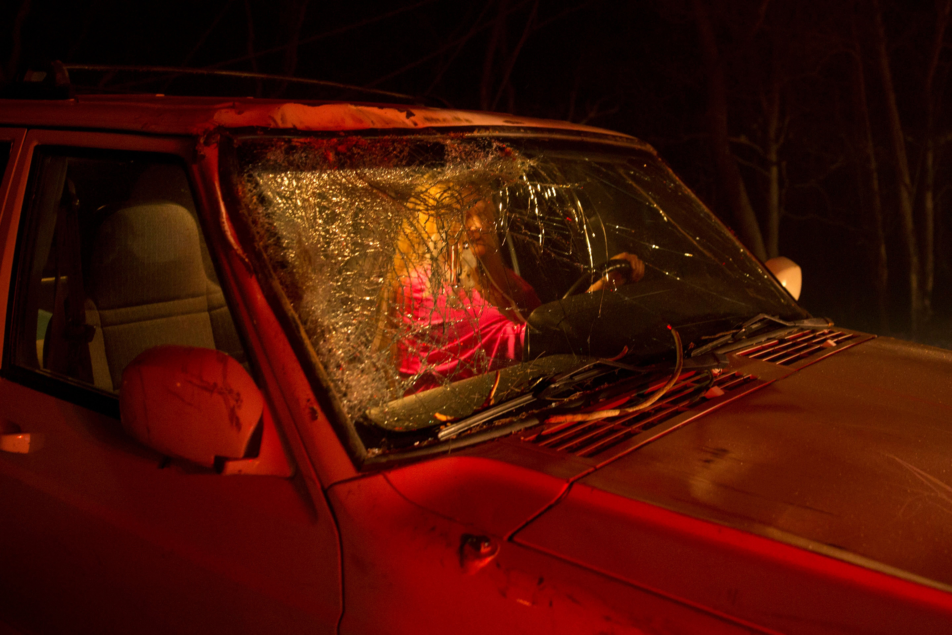 The unidentified driver who narrowly survived after a large tree fell on to the road and cracked the windshield during the Camp Fire, as it burned out of control through Paradise, Calif. on Nov. 8. (Peter Dasilva—EPA-EFE/Shutterstock)