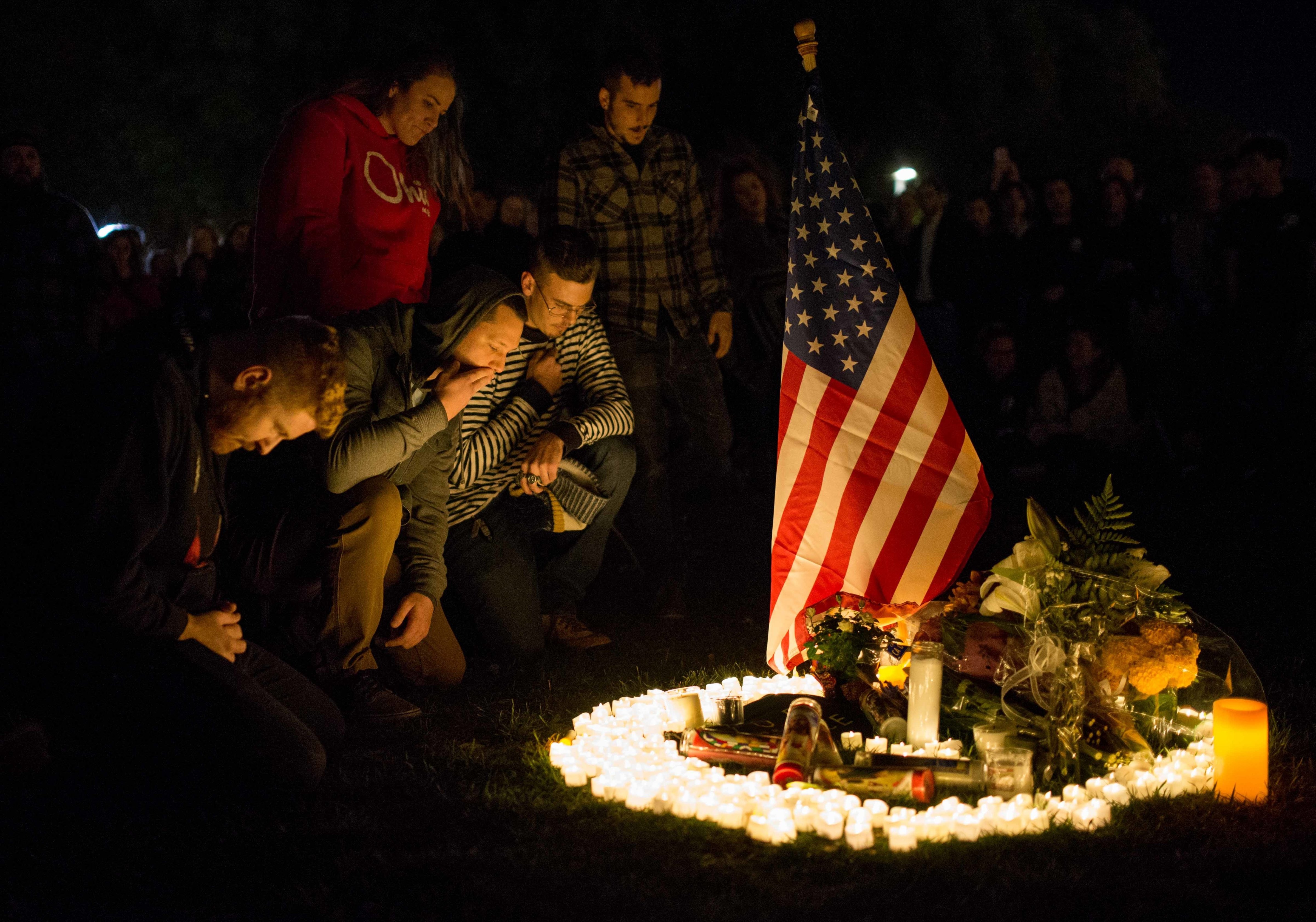 Family members of the victims seen paying tribute at the monument for the victims during the vigil on November 8. (SOPA Images&mdash;Getty Images)