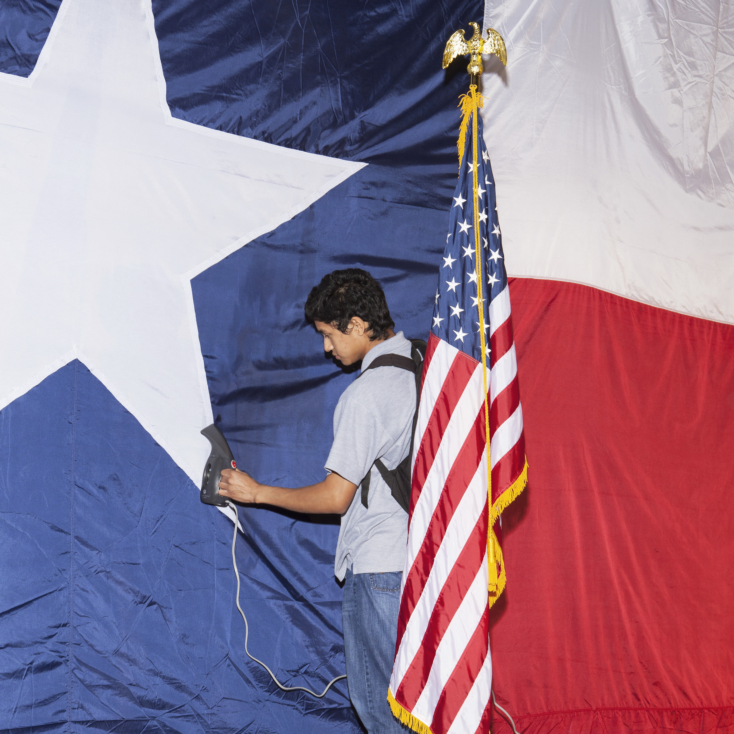 Jose Maybit Lopez, an intern for Texas Sen. Ted Cruz, steams a flag in preparation for the Election Night party in Houston. (Brent Humphreys for TIME)