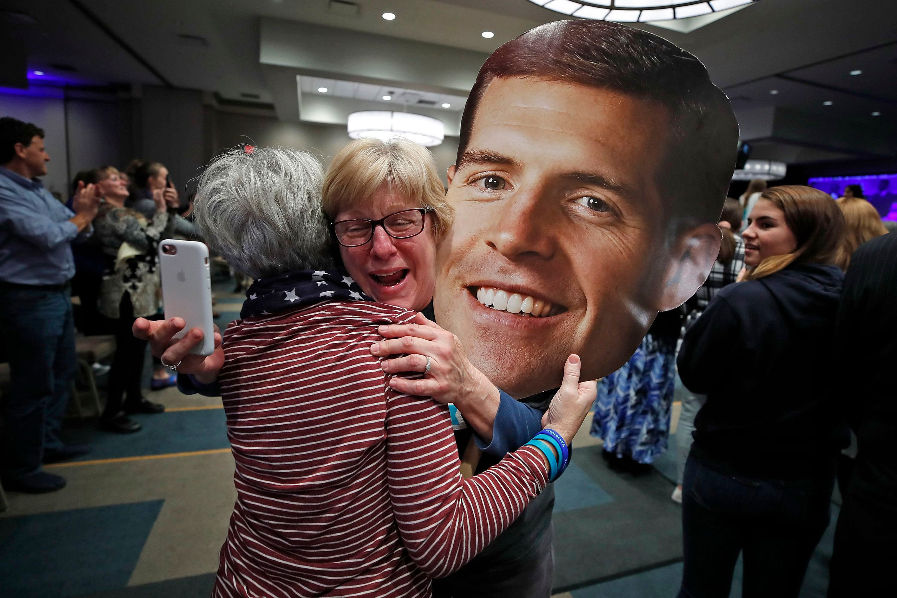 Supporters of Rep. Conor Lamb, Joanie Foran, left, and Linda Bishop, begin to celebrate after hearing CNN projected Lamb the winner in Pennsylvania's 17th Congressional District, at his election night party in Cranberry, Pa. (Gene J. Puskar—AP/Shutterstock)