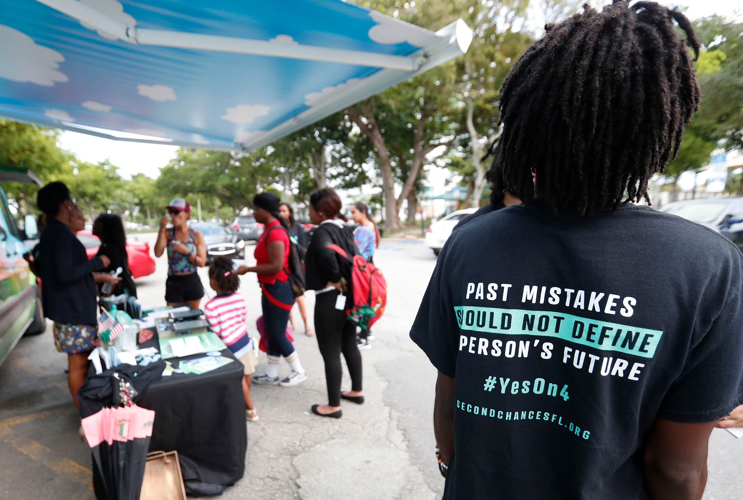 People gather around the Ben &amp; Jerry's "Yes on 4" truck as they learn about Amendment 4 and eat free ice cream at Charles Hadley Park in Miami on Oct. 22, 2018. (Wilfredo Lee—AP/Shutterstock)