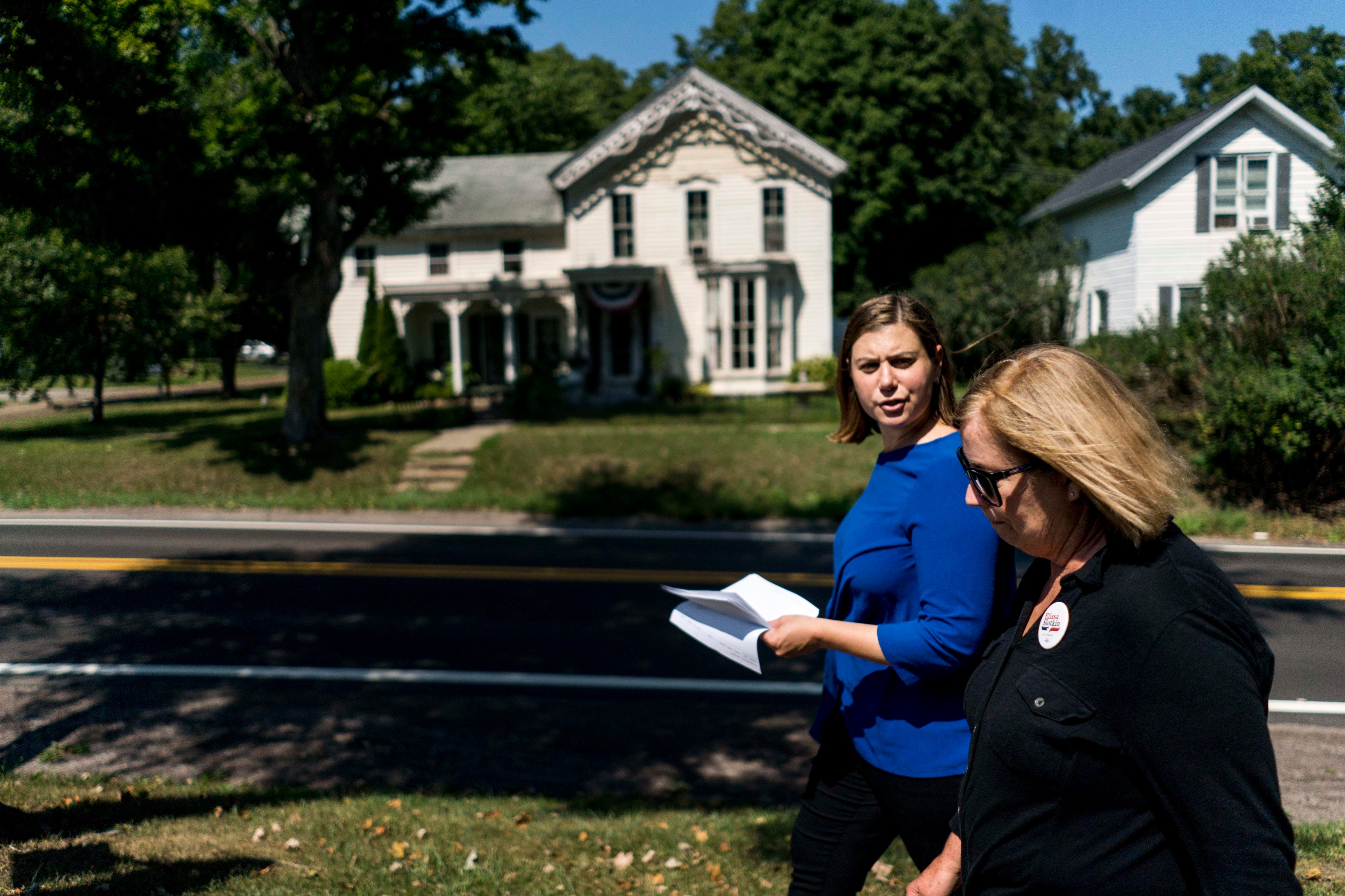 HOLLY, MICHIGAN - Elissa Slotkin, left,  Democratic candidate seeking election to the U.S. House to represent Michigan District 8, canvasses door to door with campaign volunteer Karen More near Holly, Michigan. (Photo by Melina Mara/The Washington Post --Getty Images) (The Washington Post&mdash;The Washington Post/Getty Images)