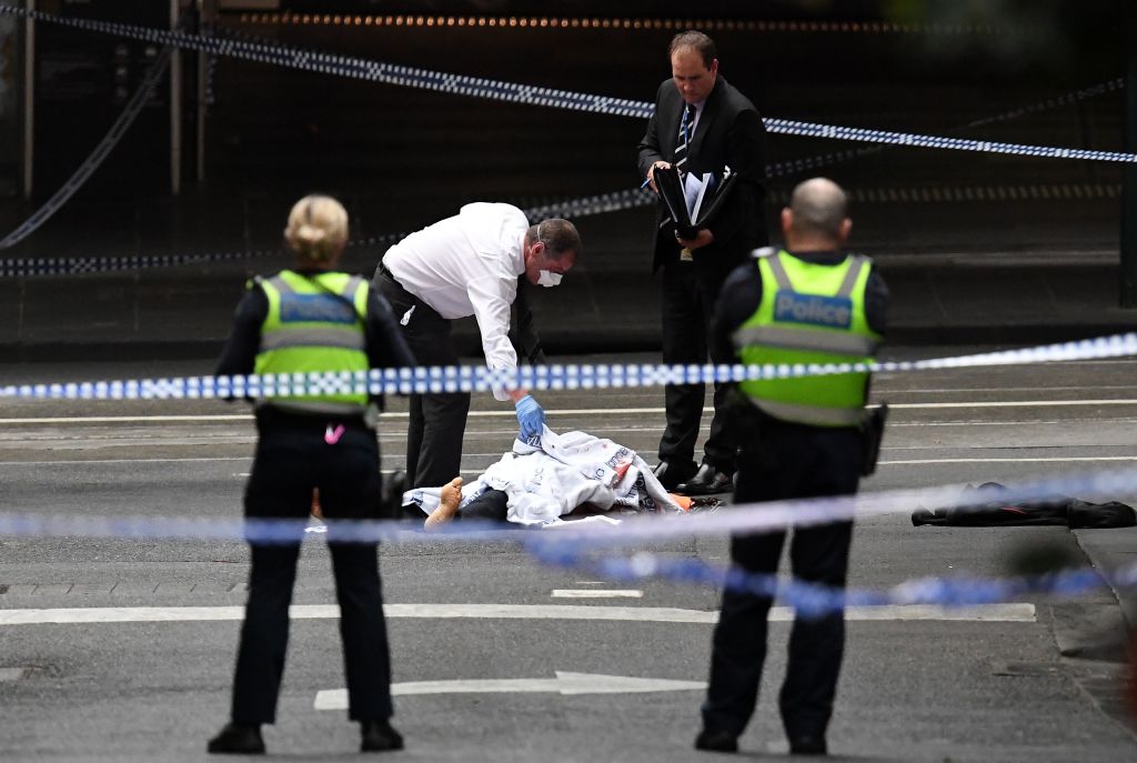 A police officer inspects the crime scene following a stabbing incident in Melbourne, Australia on Nov. 9, 2018. (William West—AFP/Getty Images)