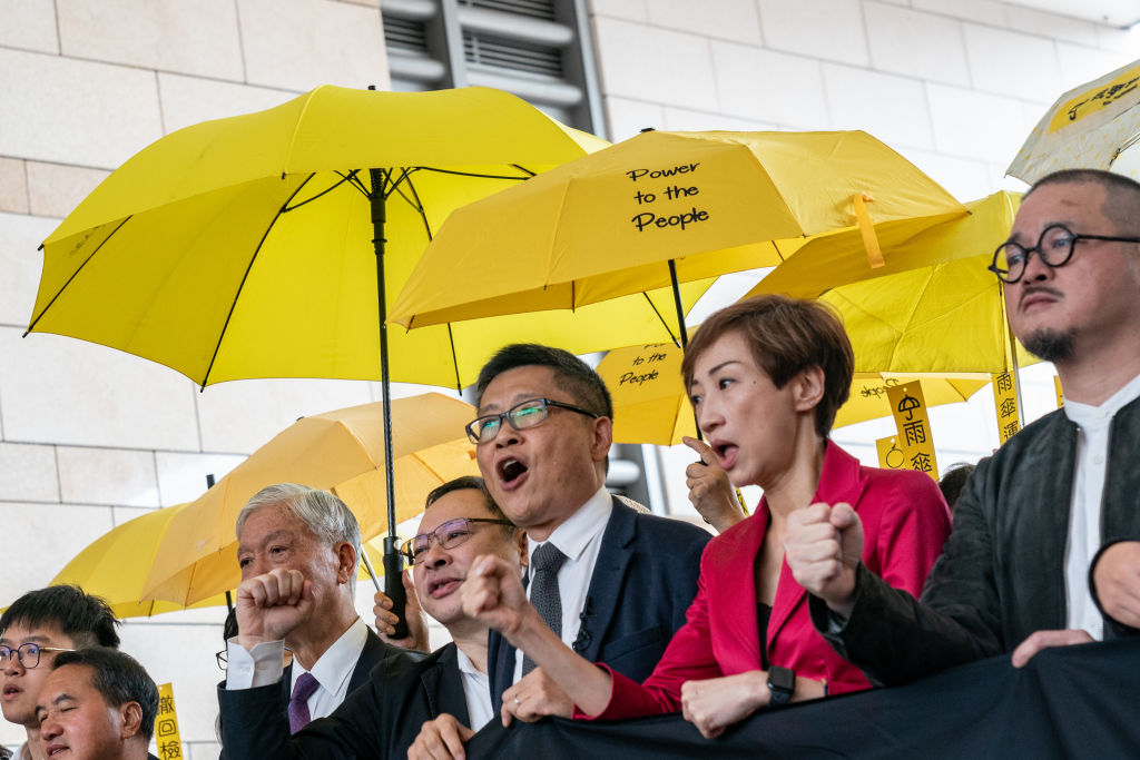 Occupy co-founders Reverend Chu Yiu-ming, Benny Tai and Chan Kin-man protest outside the West Kowloon Court on Nov. 19, 2018 in Hong Kong. (Anthony Kwan—Getty Images)