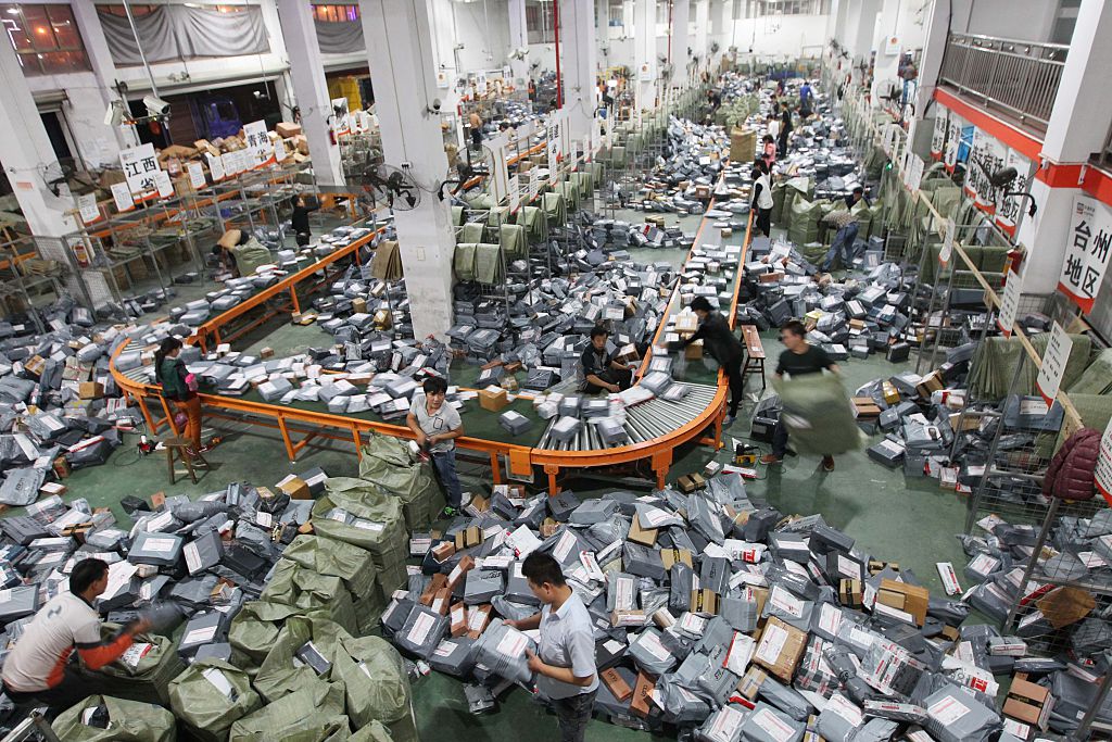 Express shipping crews deal with packages on an assembly line in Wenzhou, Zhejiang, China on Nov. 12, 2014. (VCG—Getty Images)