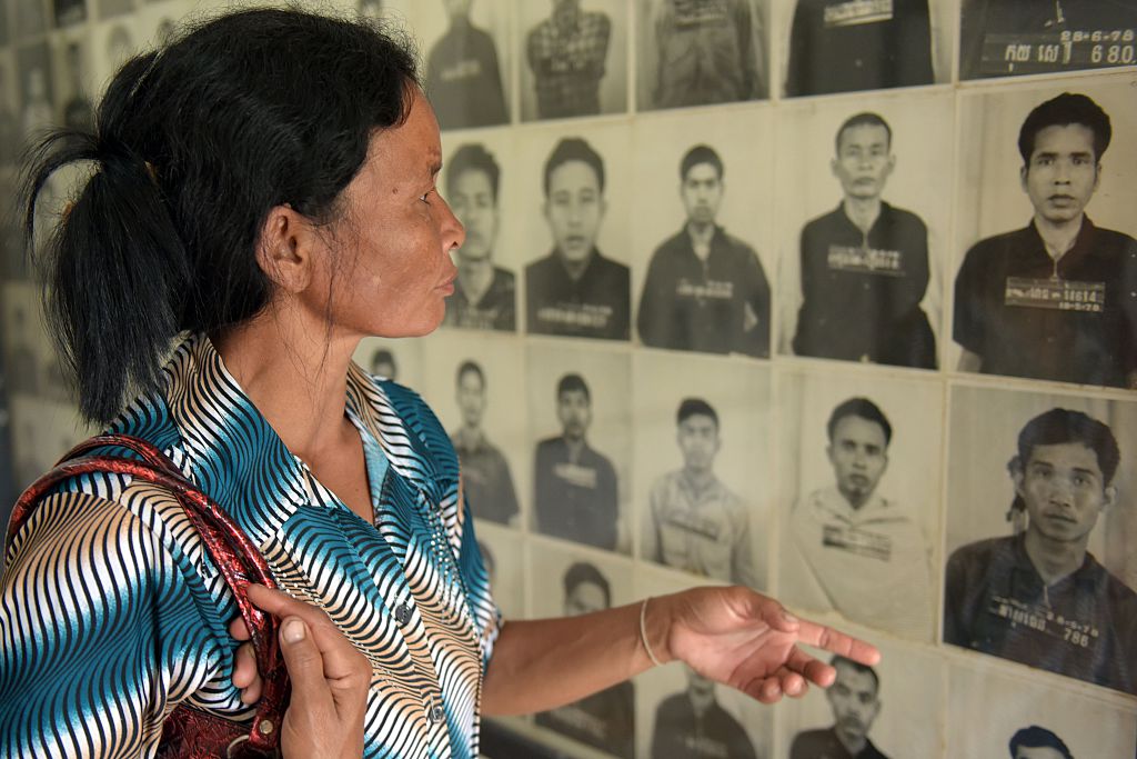 A Cambodian woman looks at portraits of victims of the Khmer Rouge at the Tuol Sleng genocide museum (S-21) in Phnom Penh, Cambodia on Aug. 24, 2015. (Tang Chhin Sothy—AFP/Getty Images)