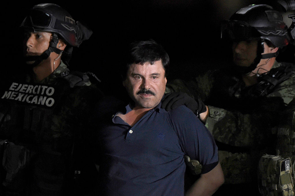 Drug kingpin Joaquin "El Chapo" Guzman is escorted into a helicopter at Mexico City's airport on Jan. 8, 2016. (Alfredo Estrella&mdash;AFP/Getty Images)