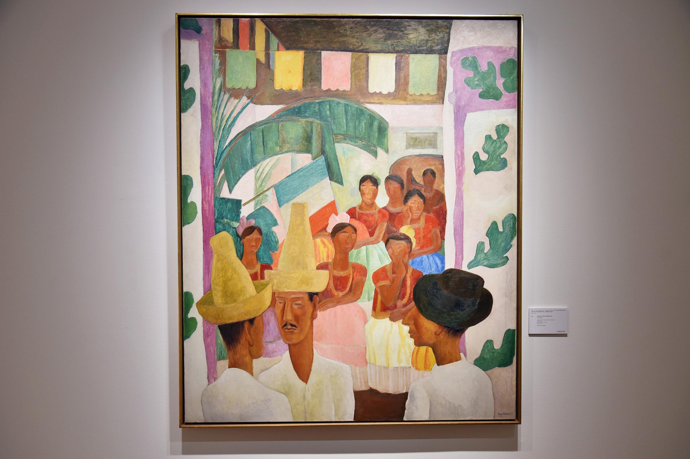 "The Rivals" by Diego Rivera is seen during a Christie's preview presenting the collection of Peggy and David Rockefeller, in New York on April 27, 2018. - A Diego Rivera painting set a record the evening of May 9, 2018 for the highest price paid at auction for a Latin American artwork, fetching $9.76 million and taking the honor away from his partner Frida Kahlo.The colorful painting entitled "Los Rivales" (The Rivals) and sold by Christie's depicts two men at a traditional Mexican celebration.