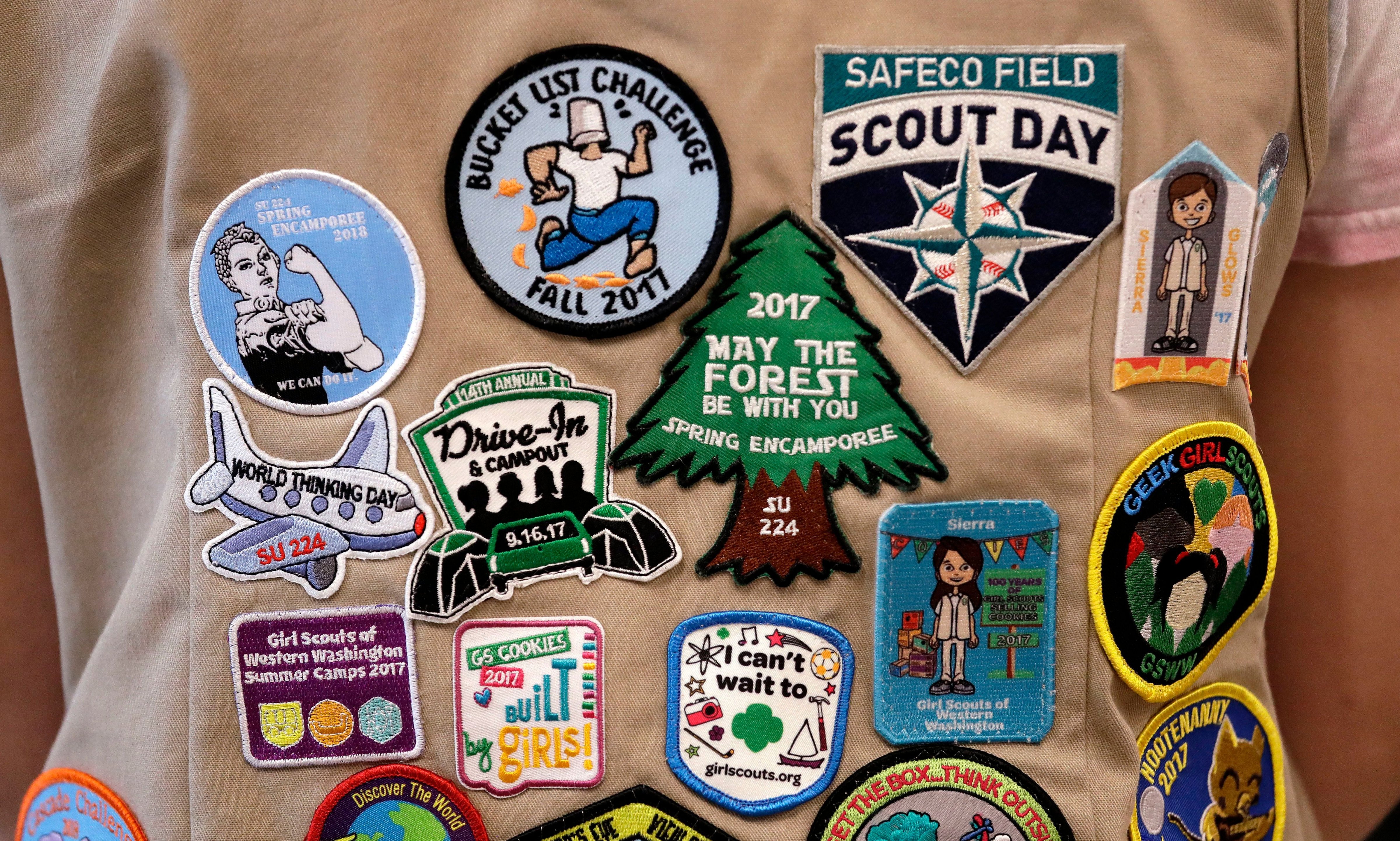 In this June 18, 2018 file photo, patches cover the back of a Girl Scout's vest at a demonstration of some of their activities in Seattle. (Elaine Thompson—AP/REX/Shutterstock)