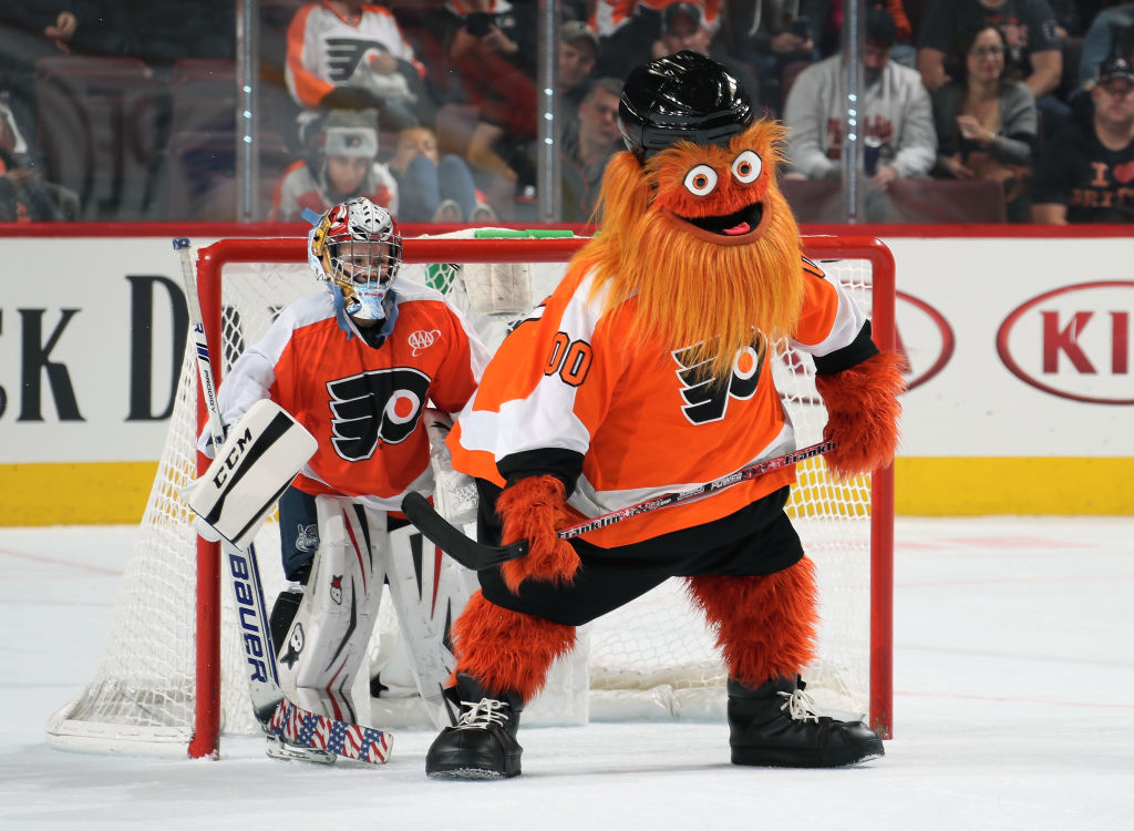 PHILADELPHIA, PA - OCTOBER 09:  Gritty the mascot of the Philadelphia Flyers plays hockey with a member of the mites on ice during the second intermission against the San Jose Sharks on October 9, 2018 at the Wells Fargo Center in Philadelphia, Pennsylvania.  (Photo by Len Redkoles/NHLI via Getty Images) (Len Redkoles—NHLI via Getty Images)