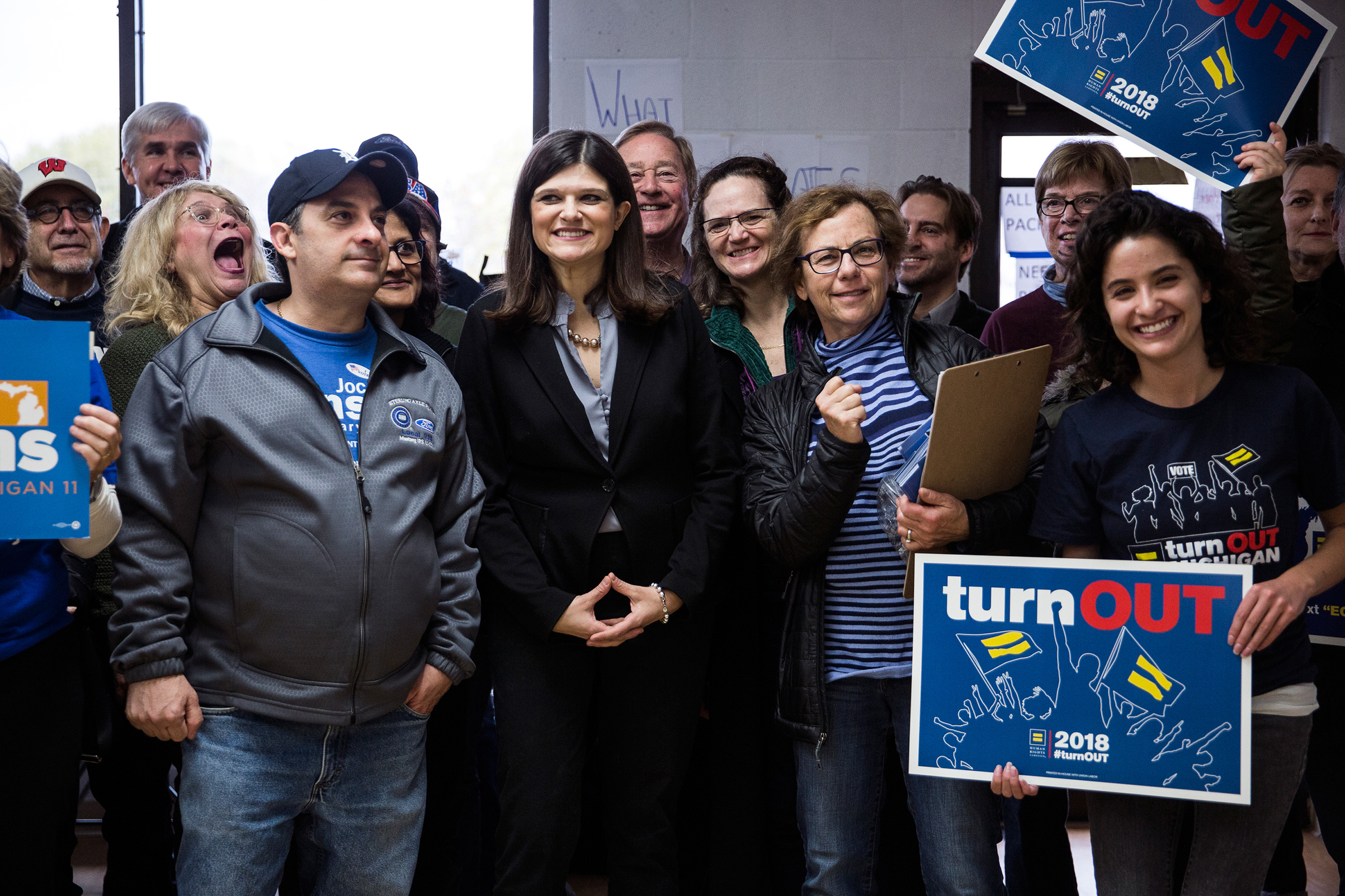 Democratic candidate for Michigan's 11th Congressional District Haley Stevens, center, poses for a picture with supporters and volunteers while launching election day canvassing at Stevens' Field Office in Troy, Mich, on Nov. 6, 2018. (Erin Kirkland for TIME)