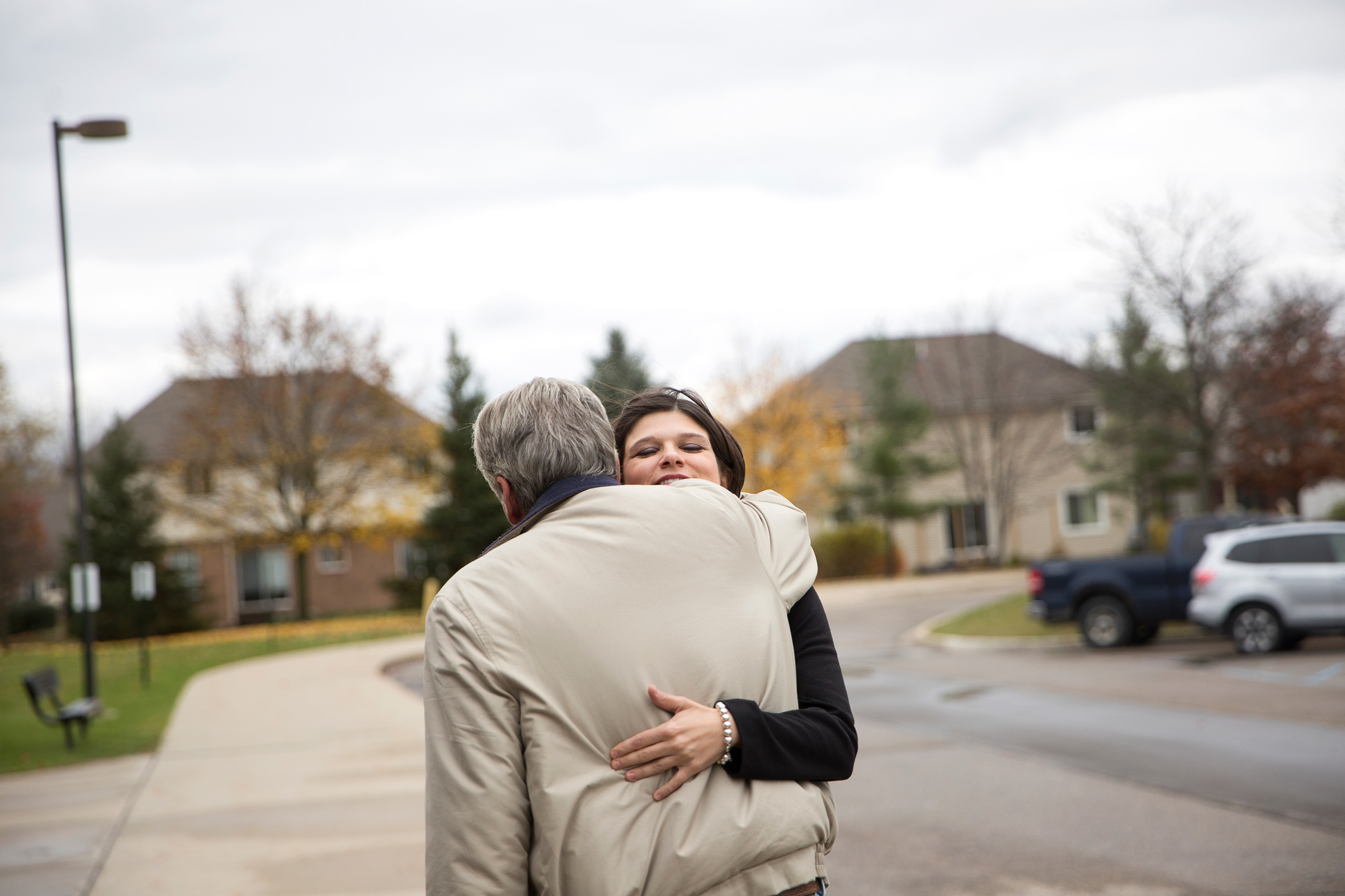 Democratic candidate for Michigan's 11th Congressional District Haley Stevens hugs her neighbor after running into him while voting at Deerfield Elementary School in Rochester Hills, Mich, on Tuesday, Nov. 6, 2018. (Erin Kirkland for TIME)