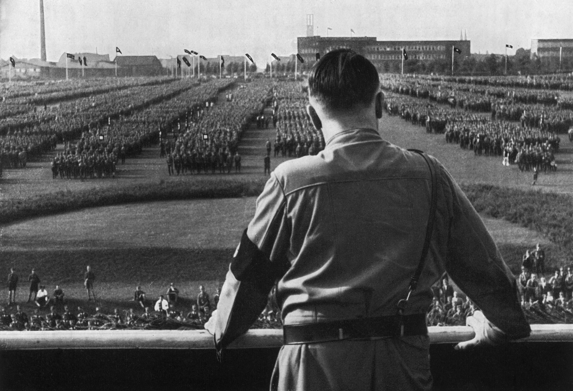 German Fuhrer and Nazi leader Adolf Hitler (1889 - 1945) addresses soldiers with his back facing the camera at a Nazi rally in Dortmund, Germany, in the 1930s. (Hulton Archive/Getty Images)