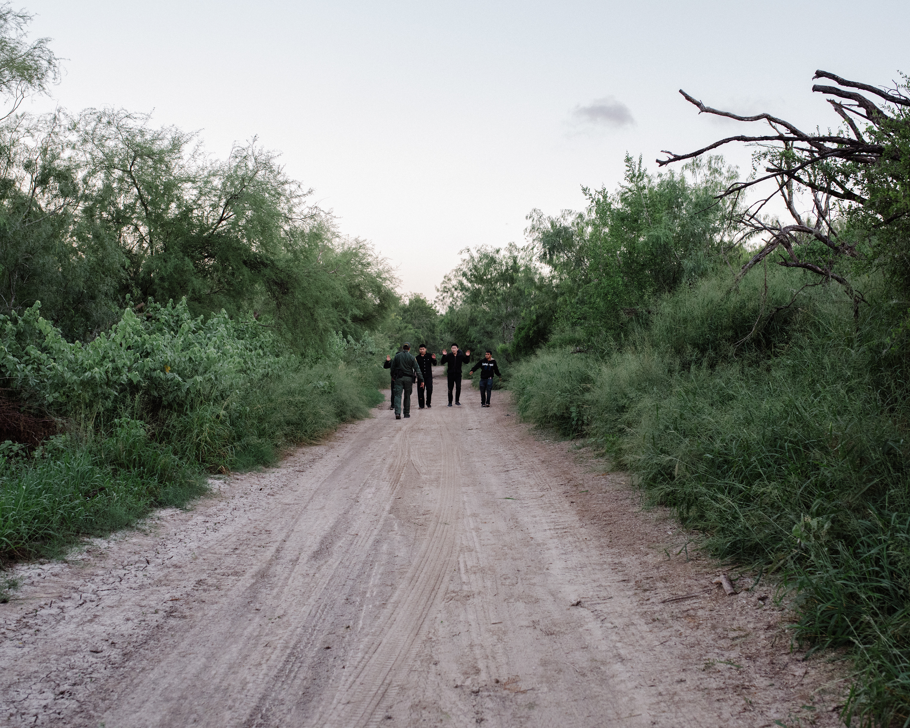 Migrants who crossed the Rio Grande into McAllen are approached by a border officer on Sept. 25. (John Francis Peters for TIME)