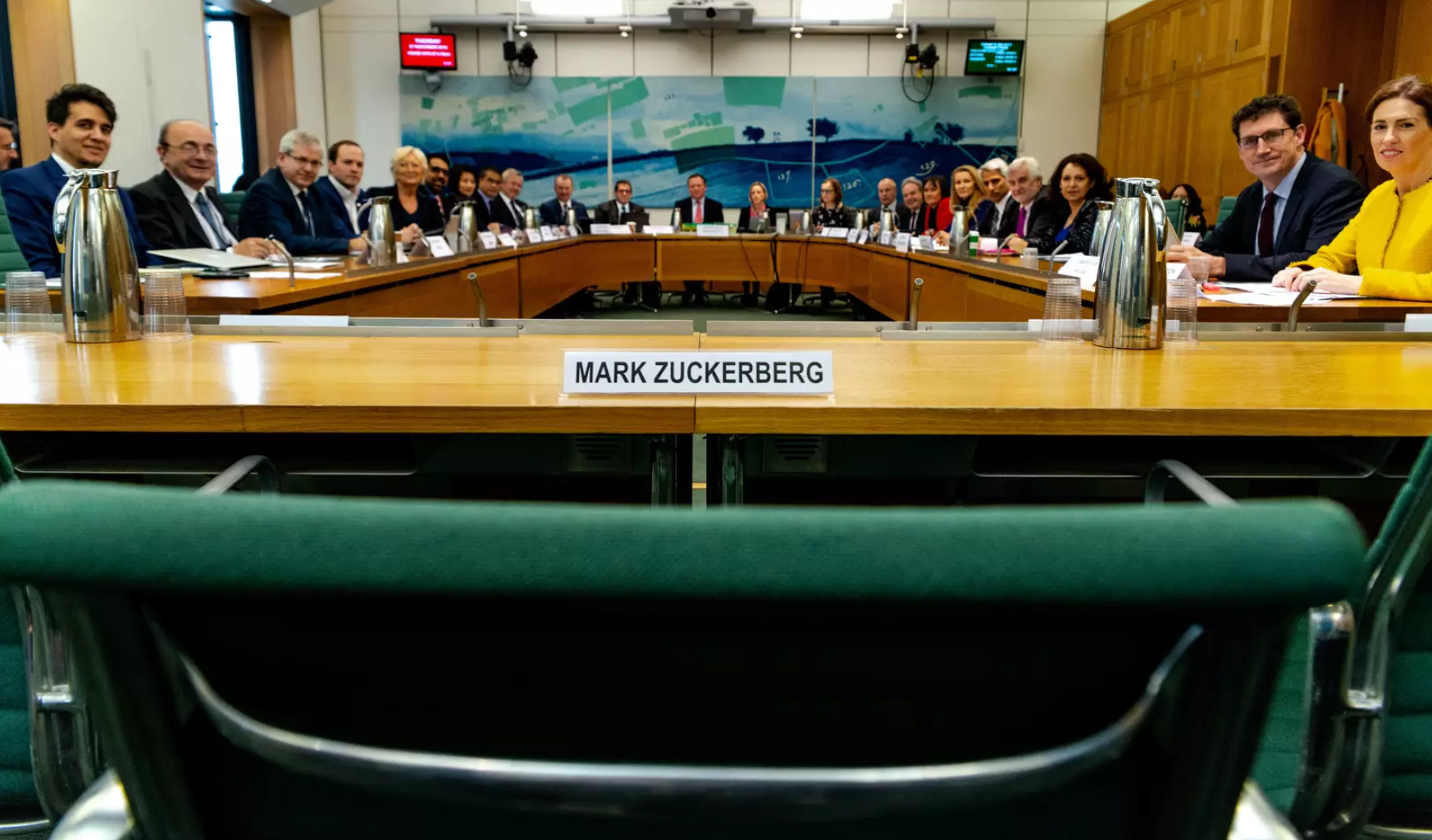 An empty chair represents Mark Zuckerberg's refusal to attend a hearing in the U.K. parliament, where representatives from nine countries gathered to demand answers from Facebook on Nov. 27 in London. (Gabriel Sainhas, House of Commons)