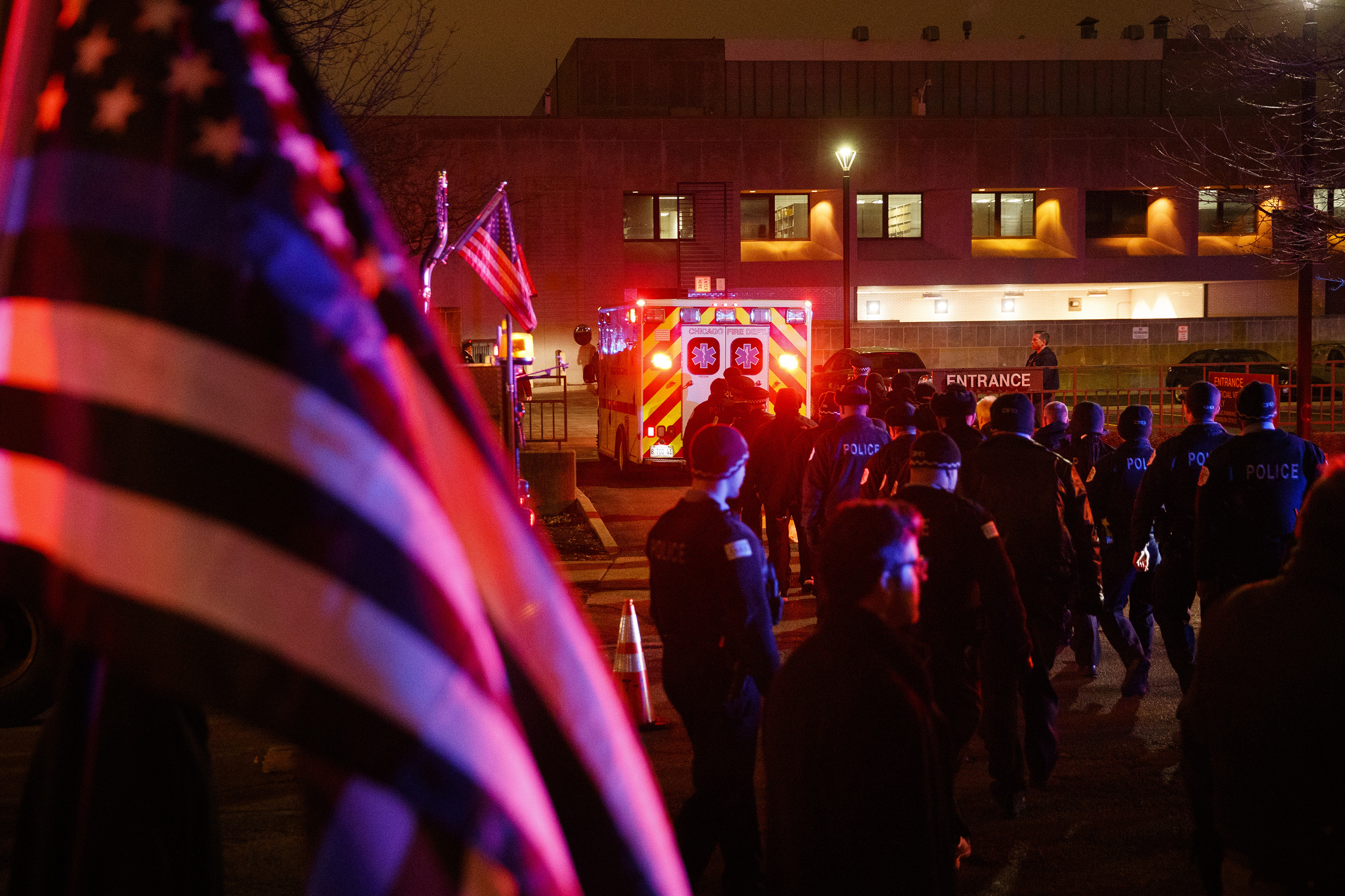 Officers follow an ambulance as it arrives at the medical examiners office carrying the body of a police officer who was killed during a shooting at Mercy Hospital which left four people, including the gunman, dead Monday Nov. 19, 2018 in Chicago. (Armando L. Sanchez/Chicago Tribune/TNS via Getty Images) (Chicago Tribune&mdash;TNS via Getty Images)