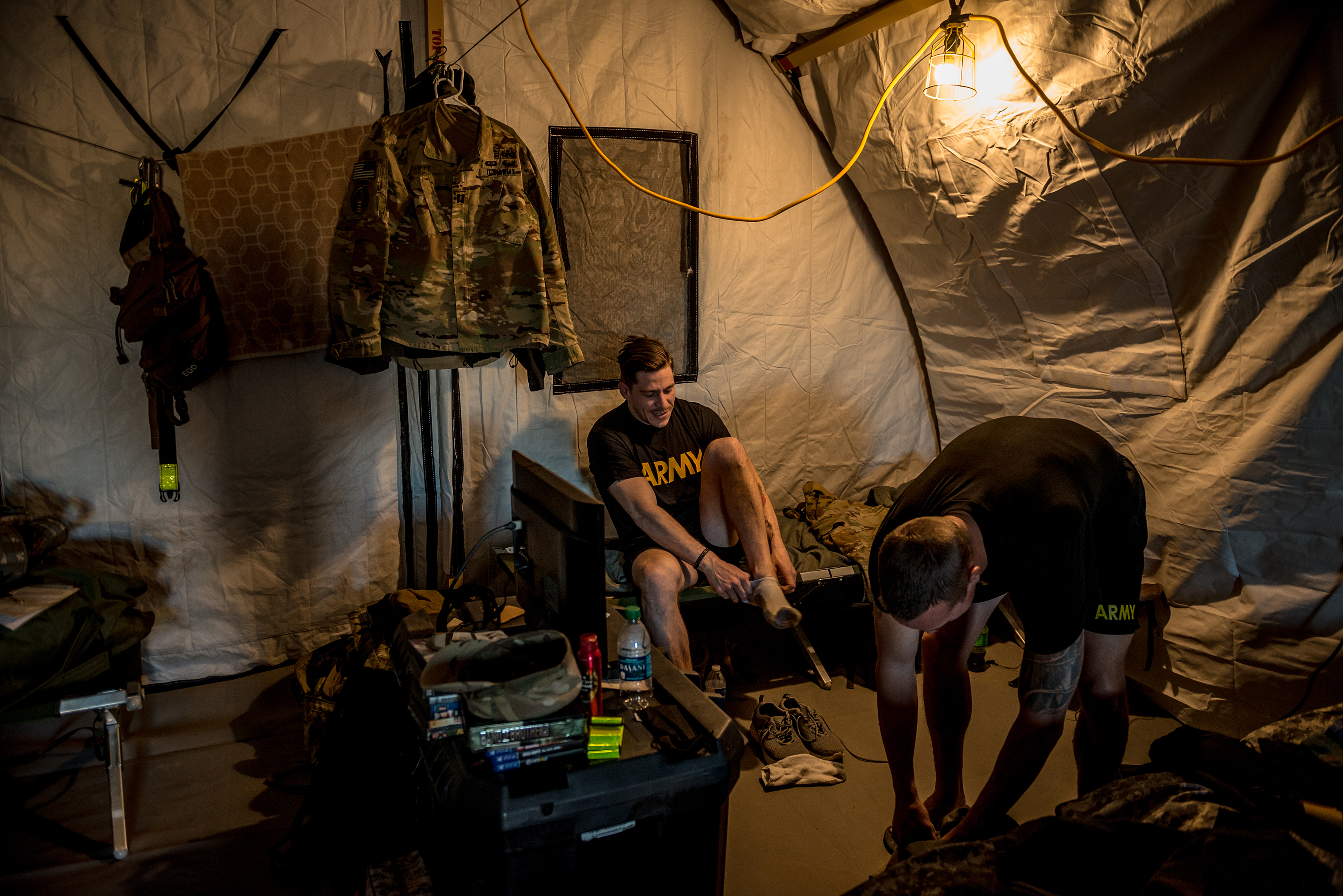 Cpt. Jacob Riffe, 29, from Augusta, Ga., puts his shoes on after waking up just after dawn inside his unit's tent. (Meridith Kohut for TIME)