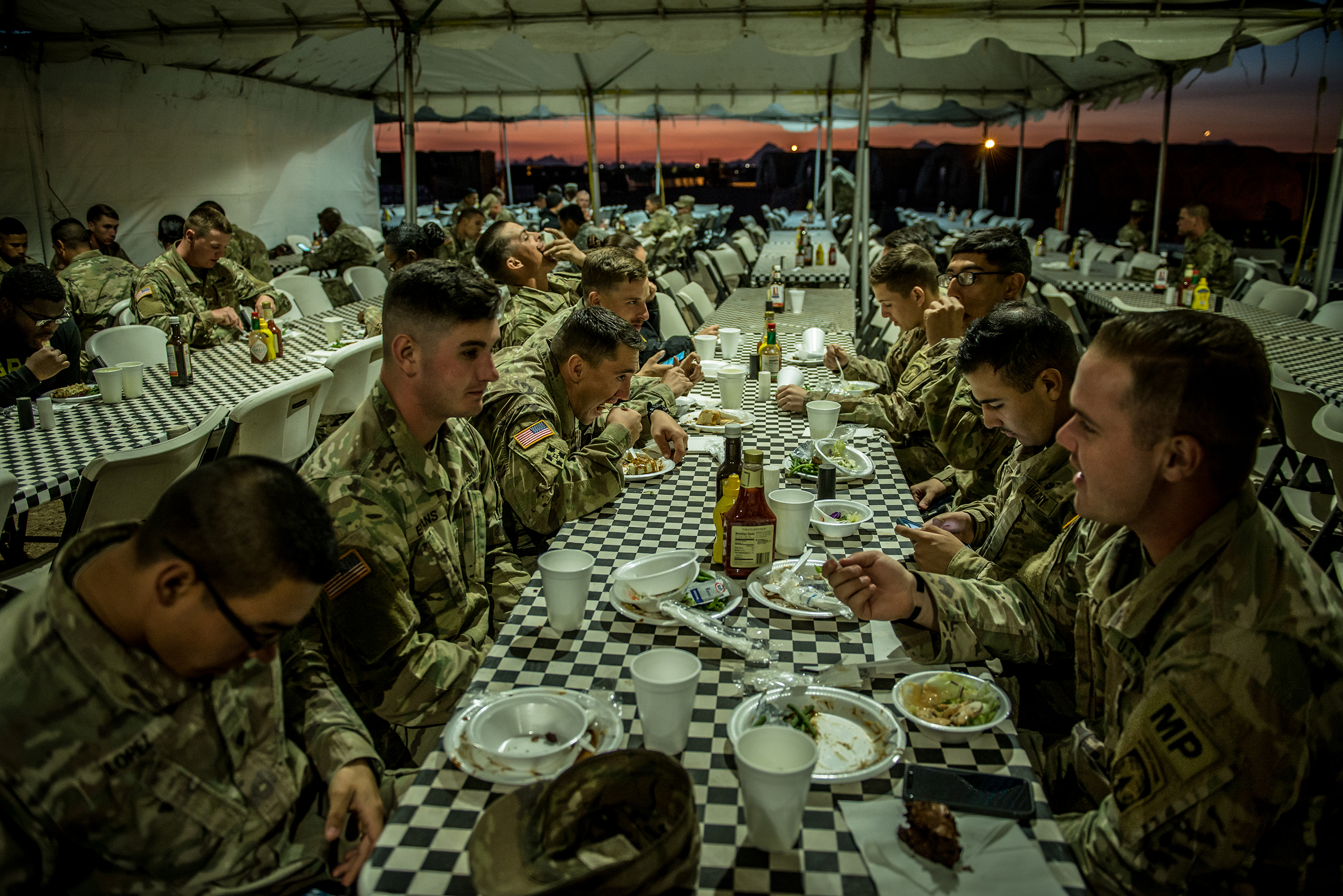 Soldiers eat dinner in the chow tent, where a Thanksgiving meal would be served, in Sunglow City, an outpost constructed in Tucson, Ariz. (Meridith Kohut for TIME)