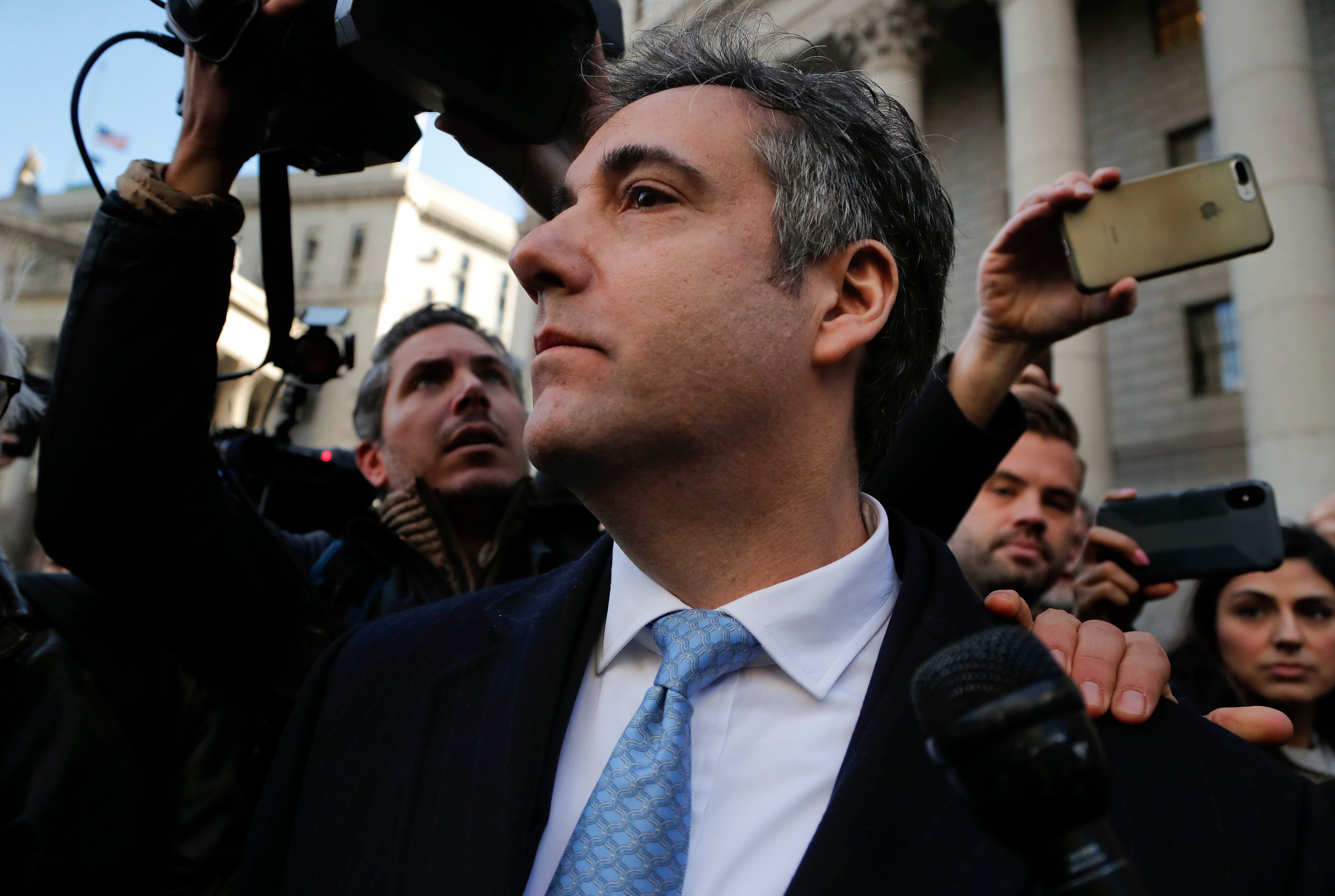 Michael Cohen walks out of federal court, in New York, after pleading guilty to lying to Congress about work he did on an aborted project to build a Trump Tower in Russia, on Nov. 29, 2018. (Julie Jacobson—AP/REX/Shutterstock)