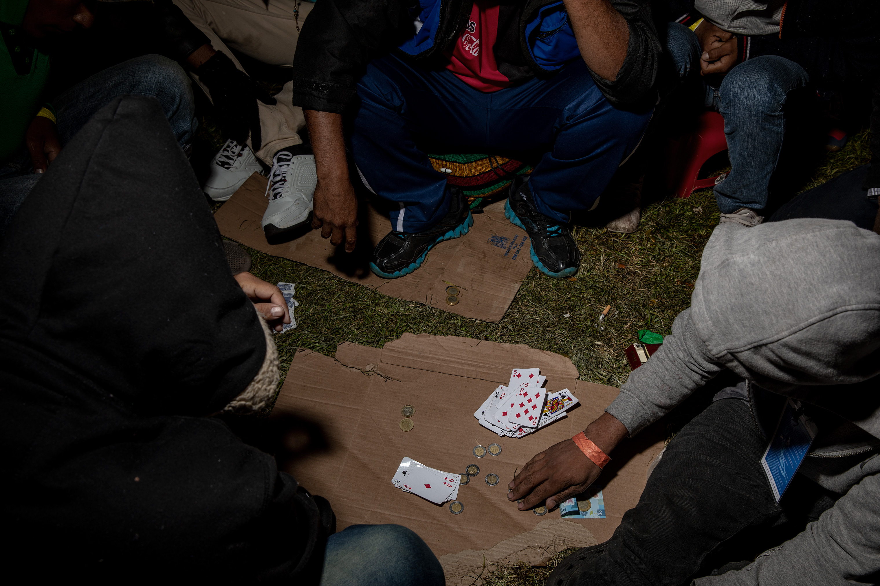 To pass the time at the stadium, migrants play cards, Nov. 9, 2018. (Jerome Sessini—Magnum Photos for TIME)