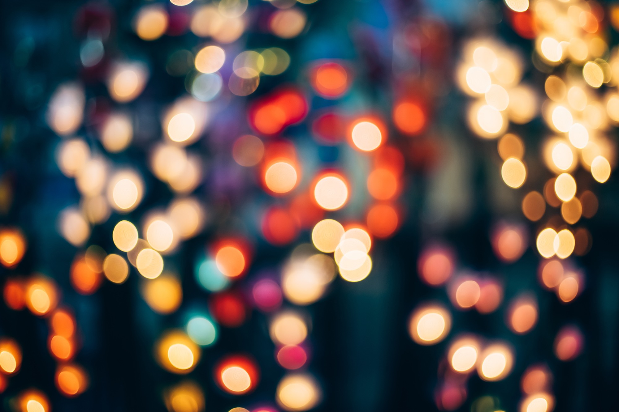 Defocused Image Of Illuminated Christmas Lights