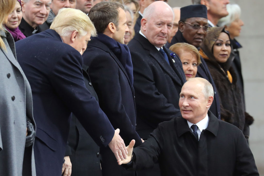 Russian President Vladimir Putin (R) shakes hands with U.S. President Donald Trump as he arrives to attend a ceremony at the Arc de Triomphe in Paris on November 11, 2018 as part of commemorations marking the 100th anniversary of the 11 November 1918 armistice, ending World War I. (Ludovic Marin—AFP/Getty Images)