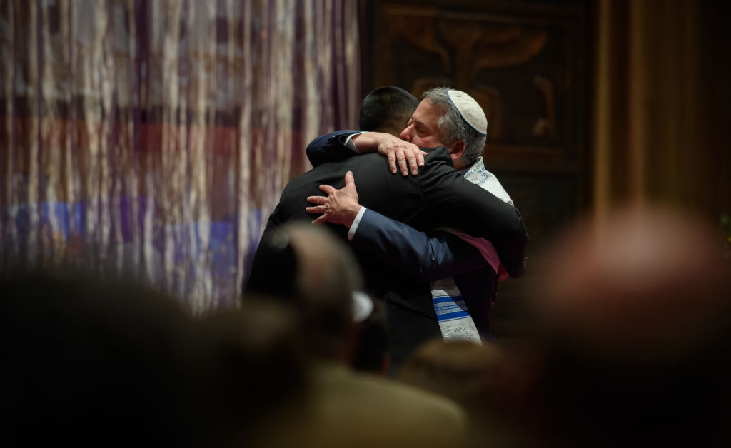 Rabbi Jamie Gibson and Wasi Mohamed embrace