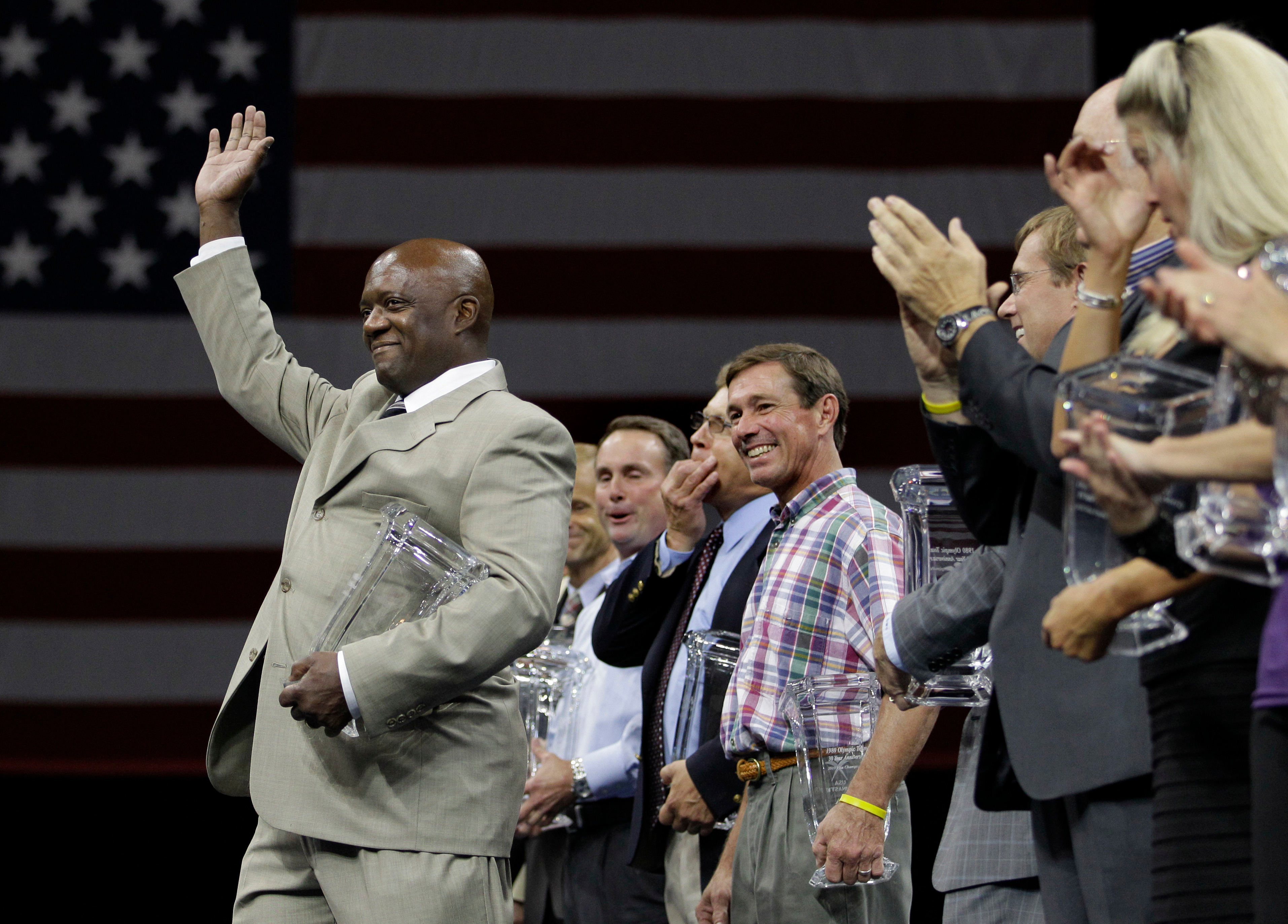 Ron Galimore waves to the crowd as he and others from the 1980 Olympic gymnastics team who did not compete due to the U.S. boycott of the Olympic Games, are honored at the U.S. Gymnastics Championships in Hartford, Conn. on August 14, 2010. On Nov. 16, 2018 it was announced that Galimore resigned from being USA Gymnastics' COO. (Elise Amendola—AP/REX/Shutterstock)