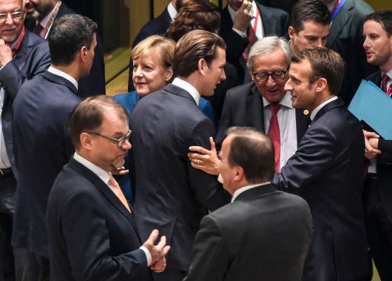 Kurz, center, speaks to European Commission President Jean-Claude Juncker and French President Emmanuel Macron at the start of a European Council summit in Brussels in October