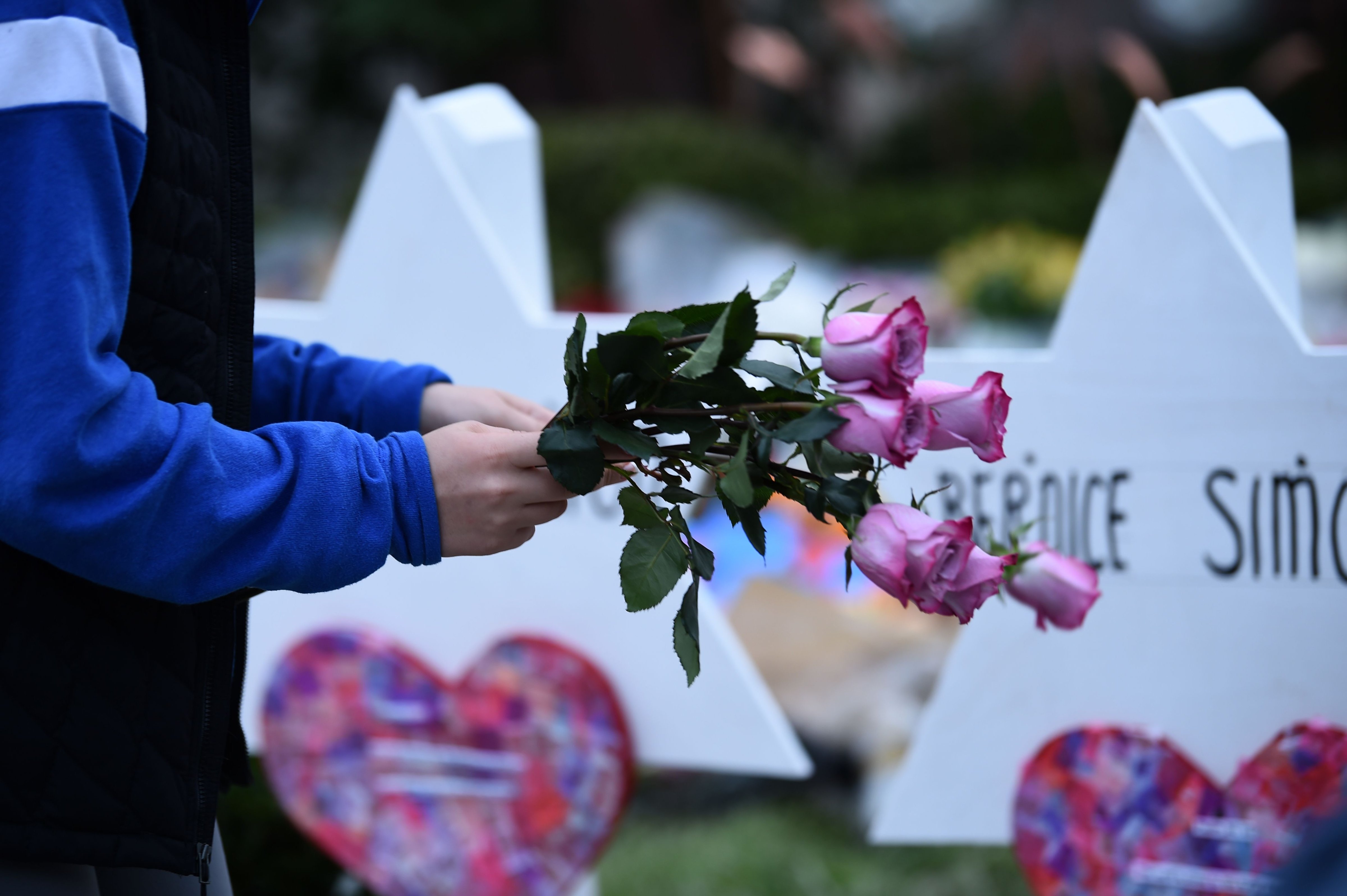 People pay their respects at a memorial outside the Tree of Life synagogue after a shooting there left 11 people dead in the Squirrel Hill neighborhood of Pittsburgh, Pennsylvania on October 29, 2018. Bernice and Sylvan Simon, married 62 years, were laid to rest Thursday. (BRENDAN SMIALOWSKI—AFP/Getty Images)