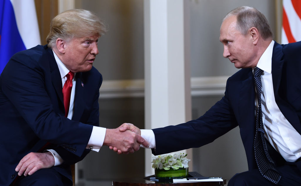 Russian President Vladimir Putin and US President Donald Trump shake hands