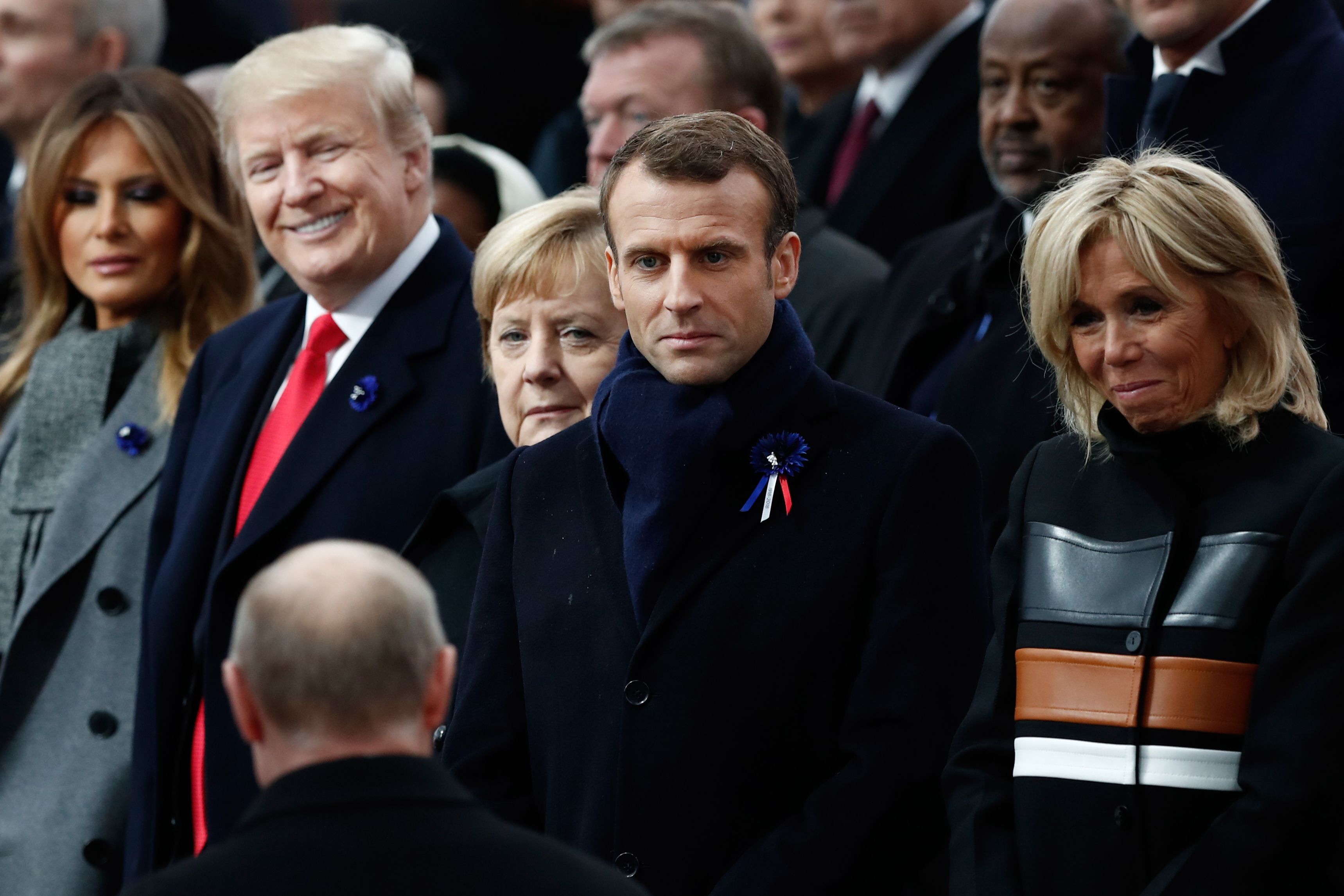 US First Lady Melania Trump, US President Donald Trump, German Chancellor Angela Merkel, French President Emmanuel Macron and French President's wife Brigitte Macron react as Russian President Vladimir Putin (front C) arrives to attend a ceremony at the Arc de Triomphe in Paris on November 11, 2018. (Getty Images)