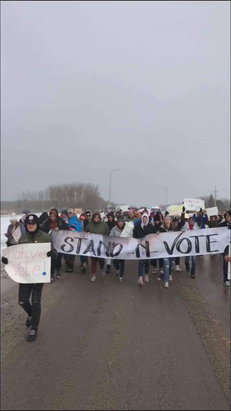Members of the Turtle Mountain youth council and tribal leaders march to a polling site near Belcourt, N.D. on Nov. 6, 2018. (Courtesy of Edward Falcon Jr.)