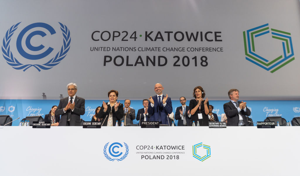 15 December 2018, Poland, Katowice: Michal Kurtyka (M), President of the UN Climate Change Conference COP24, and other participants of the climate summit are pleased about the decision of the compromise at the world climate summit. (picture alliance&mdash;picture alliance via Getty Image)