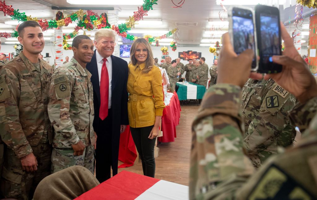 US President Donald Trump and First Lady Melania Trump take photos with members of the US military during an unannounced trip to Al Asad Air Base in Iraq on December 26, 2018. (SAUL LOEB&mdash;AFP/Getty Images)