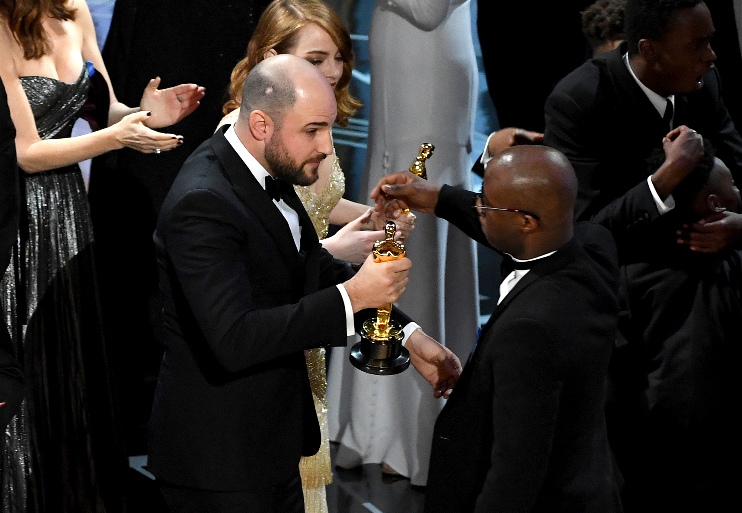 La La Land producer Jordan Horowitz hands a stunned Jenkins the Best Picture statue at the 2017 Oscars (Kevin Winter—Getty Images)