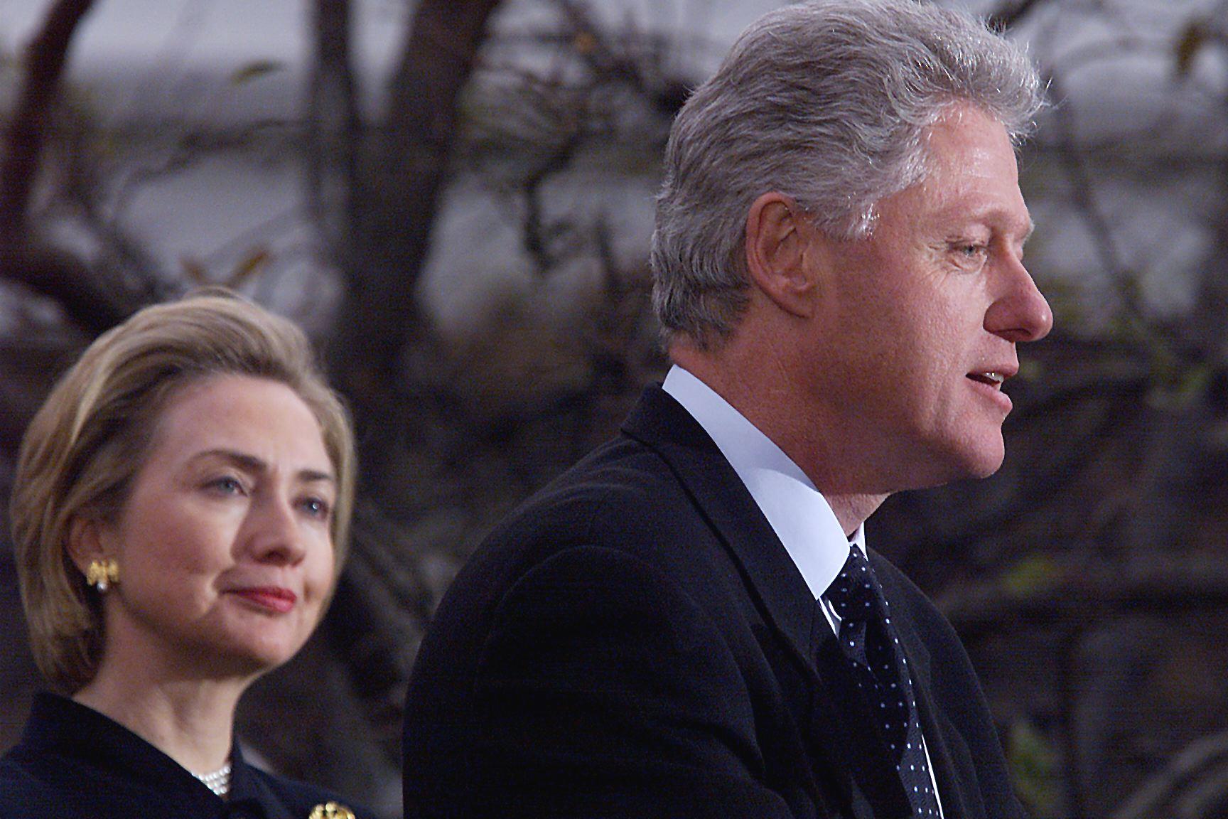President Bill Clinton (R) appears with First Lady Hillary Clinton to make a statement to reporters outside the oval office following his impeachment by the U.S. House of Representatives. (TIM SLOAN—AFP/Getty Images)