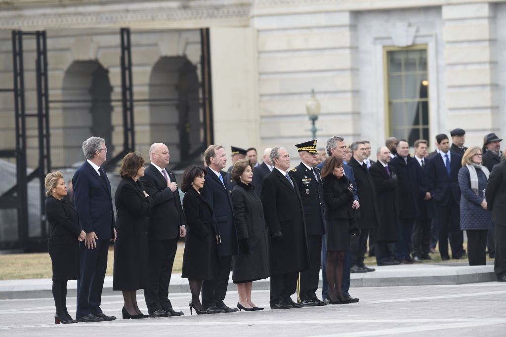 Bush family members watch as former US President George H.W. Bush departs the US Capitol
