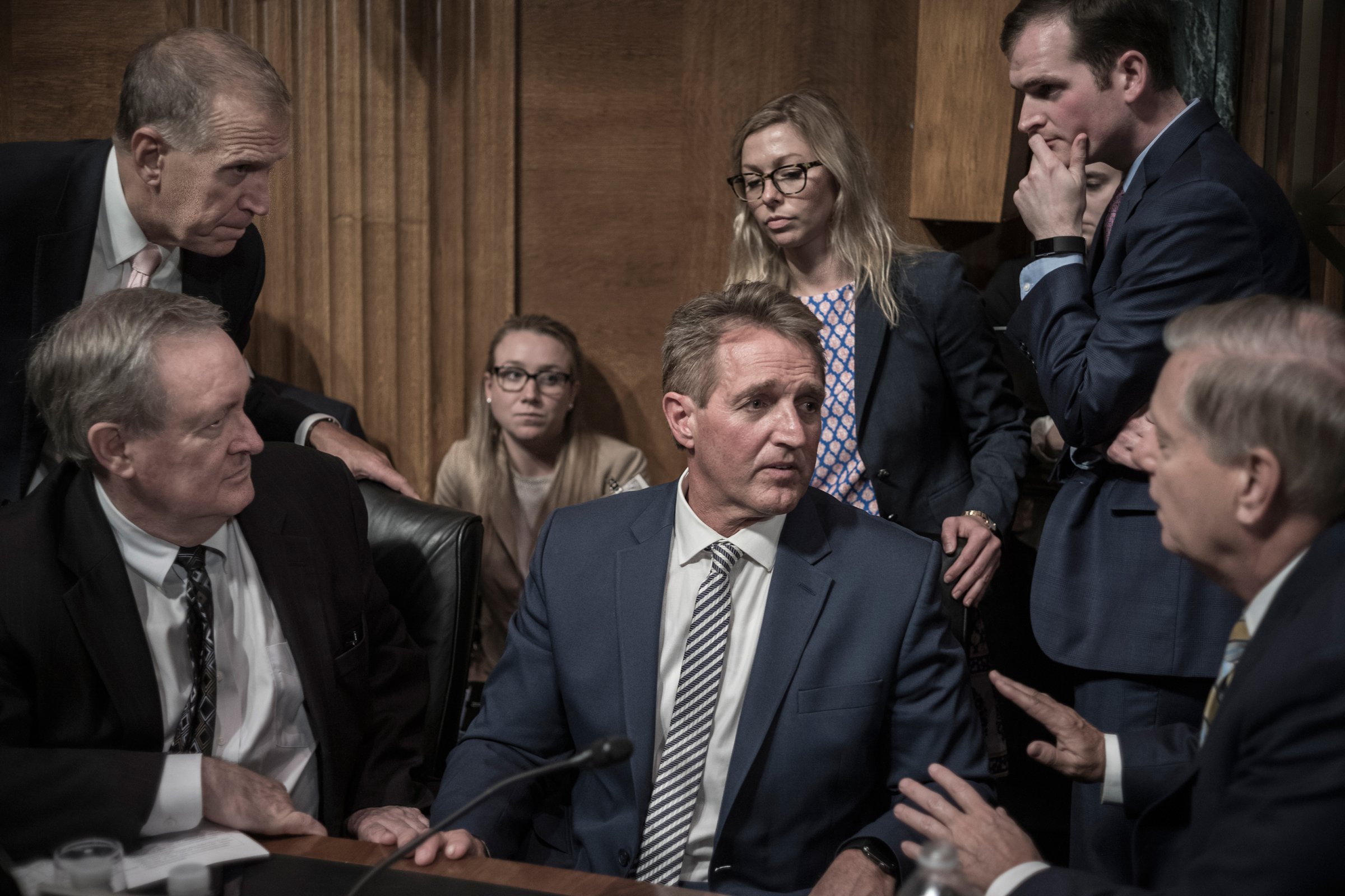 Jeff Flake, center, listens to fellow GOP Senator Lindsey Graham, right, on Sept. 28, moments after Flake called for a delay in Brett Kavanaugh’s Supreme Court confirmation