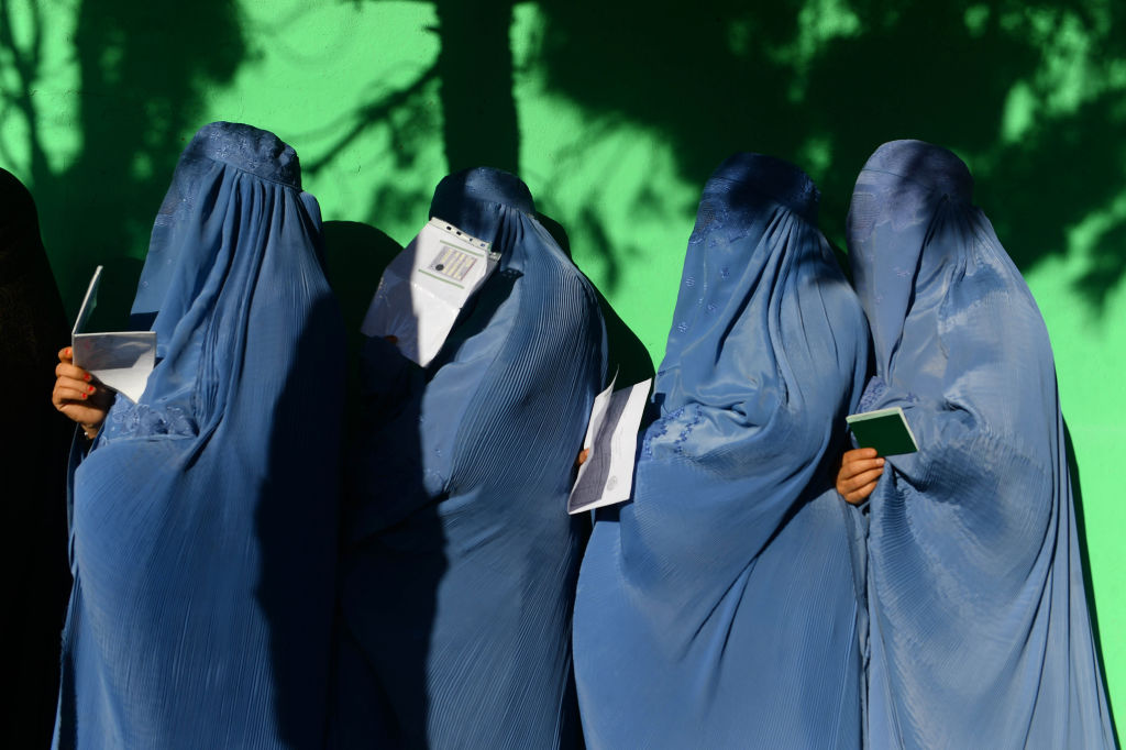 Afghan women wait in line to vote at a polling centre for the country's legislative election in Herat province on October 20, 2018. (Hoshang Hashimi—AFP/Getty Images)