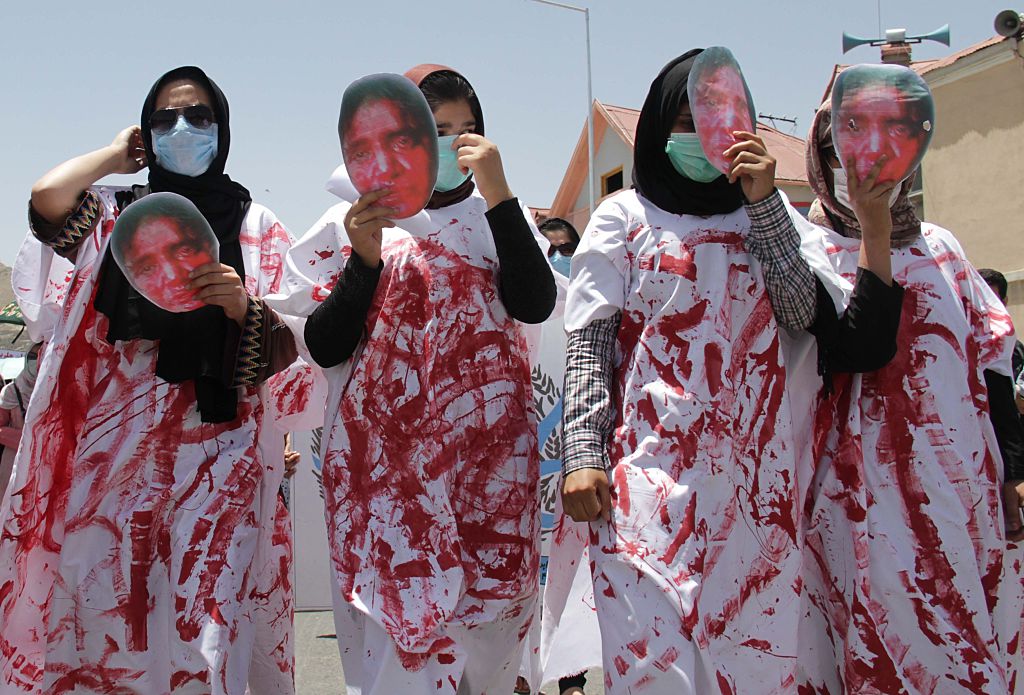 Afghan women wear masks of 27 year-old Farkhunda who was beaten to death by a mob after being falsely accused of burning a Quran, during a protest held by the Solidarity Party of Afghanistan at the site of the attack in Kabul, Monday, July 6, 2015. (Haroon Sabawoon—Anadolu Agency/Getty Images)